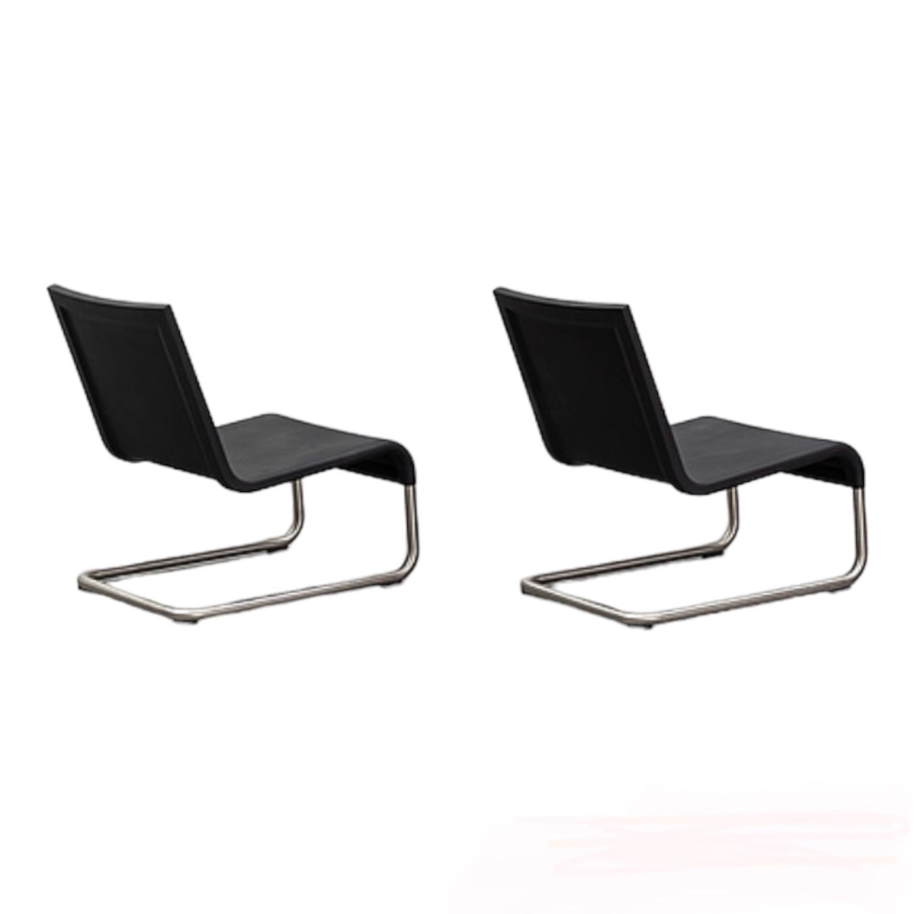 This is a pair of .06 lounge chairs, designed by Maarten van Severen for Vitra in 2005.
It has a brushed stainless steel frame, and a soft polyurethane seat that is actually quite comfortable despite being solid with no cushion.
These chairs are