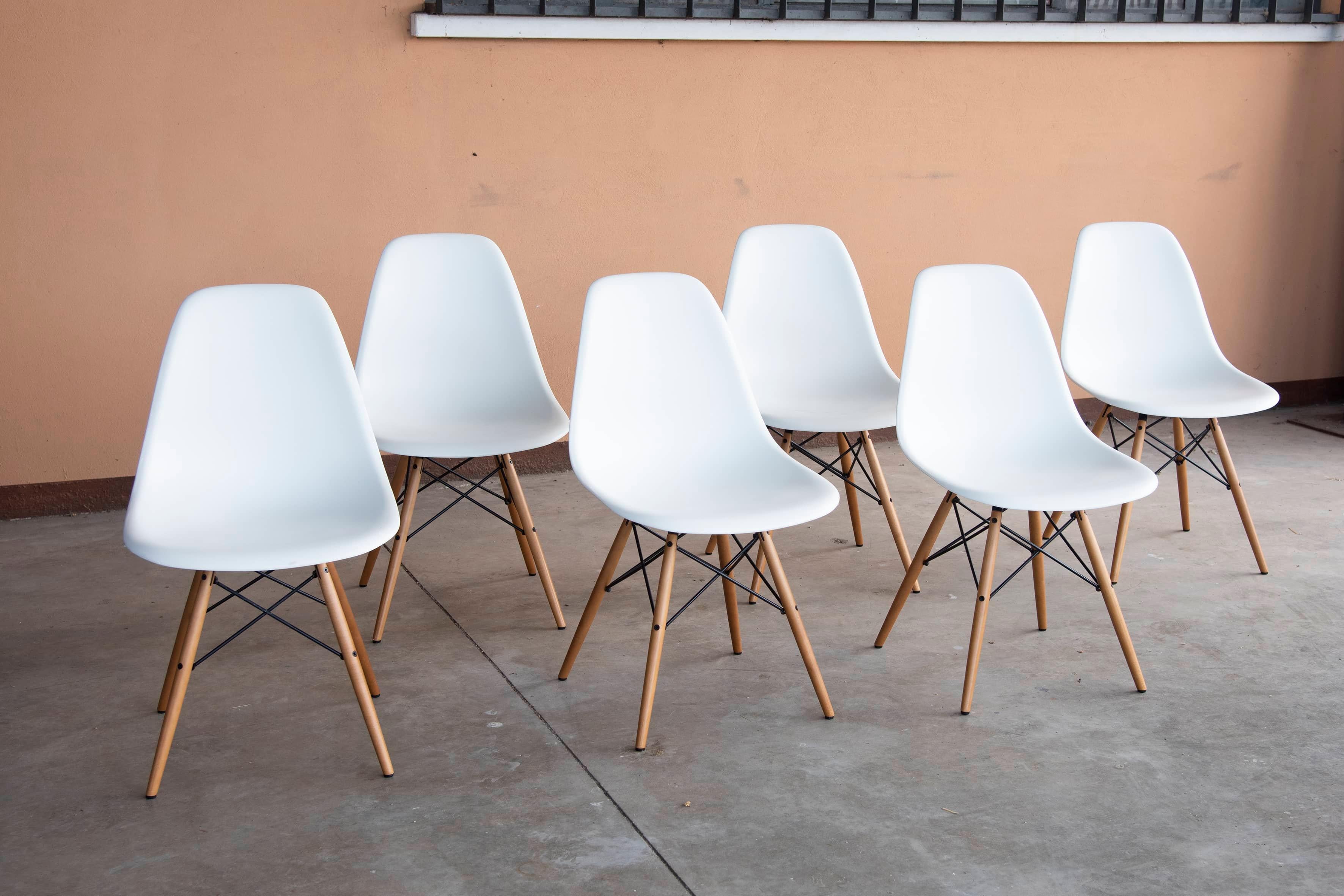 Six Eames Plastic Side Chairs DSW Designed in 1950. Newly produced chairs feature white plastic shell and light wooden legs. Perfectly preserved condition. Size: L 46,5 x D. 55 cm x H 83 cm - Seduta : H 43 cm
Price is per chair. 
