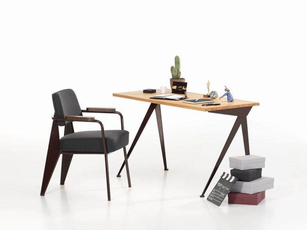 Vitra Fauteuil Direction in dark gray and chocolate by Jean Prouvé. Fauteuil Direction is especially suited for dining room seating or as an armchair in home offices. The design reflects Jean Prouvé's characteristic aesthetic vocabulary, which is
