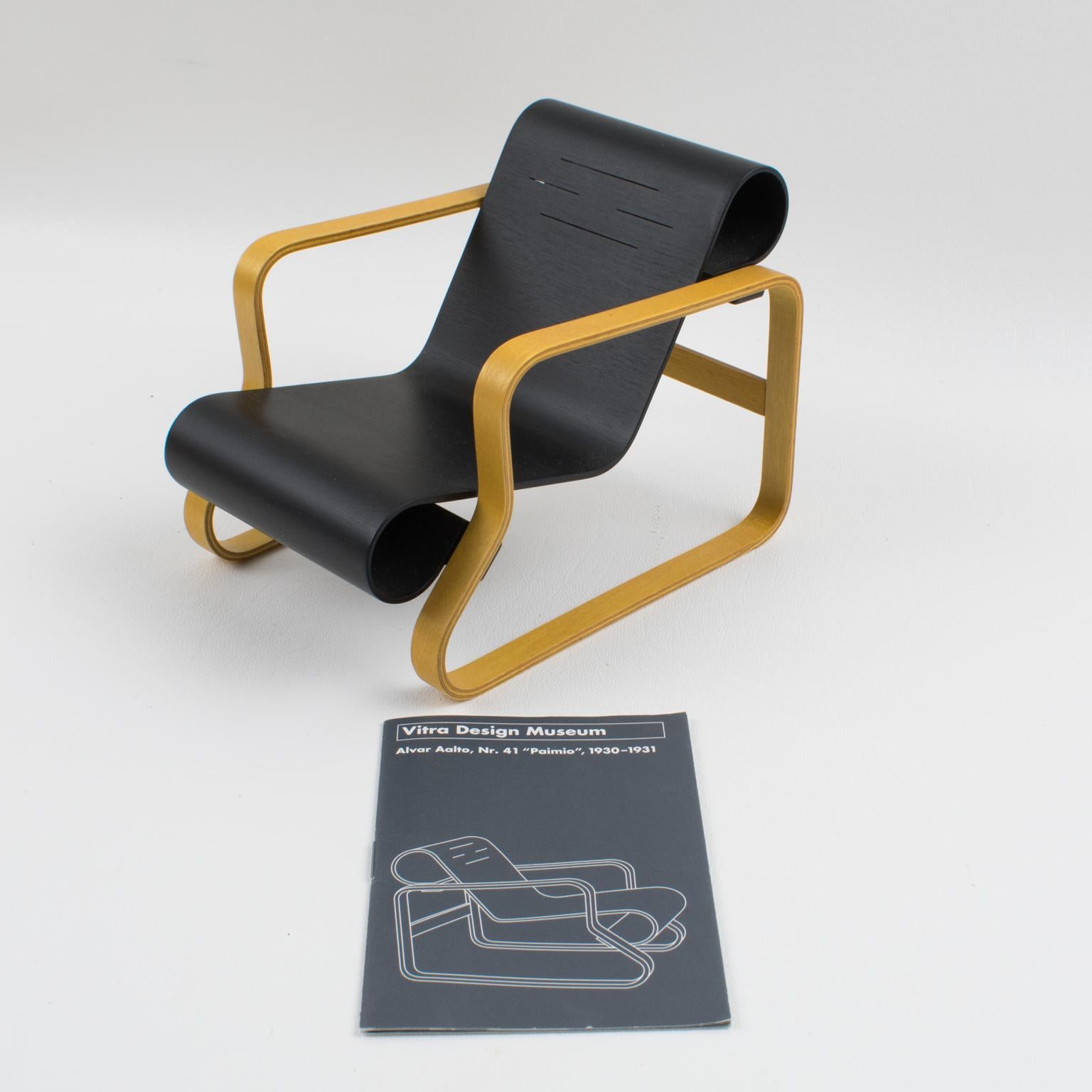 Iconic miniature Paimio chair designed by Alvar Aalto, circa 1930, and edited by Vitra. 
Alvar Aalto designed the Paimio chair in 1932-33, which revolutionized both the aesthetics and technology of modern furniture design. The arms are constructed