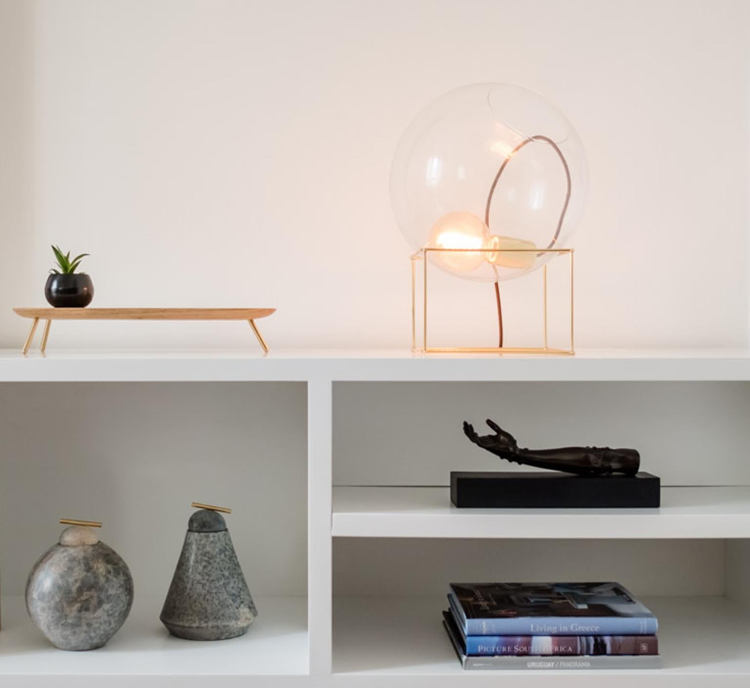 Vítrea Contemporary Decorative Minimalist and Poetic Design Table Lamp by Cristiana Bertolucci
A hollow metal cube holding up a transparent glass ball where it supports the lamp. Extremely simple delicate and inspiring.
Materials: polished or aged