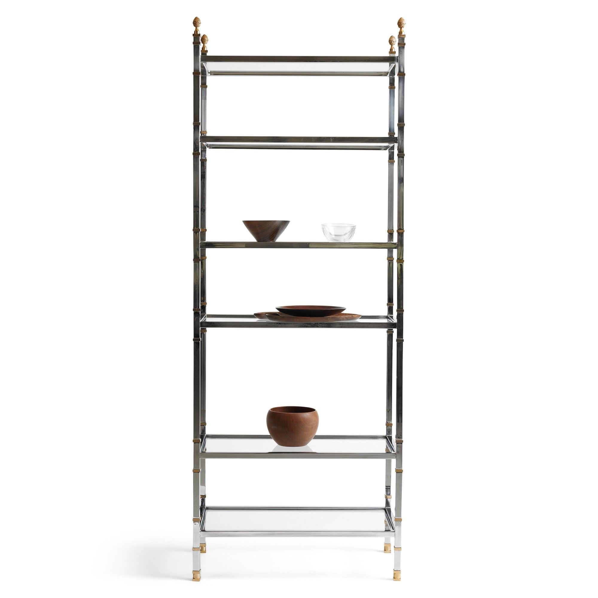 A classic vitrine showcasing six glass shelves framed in a two-tone brass and chrome.