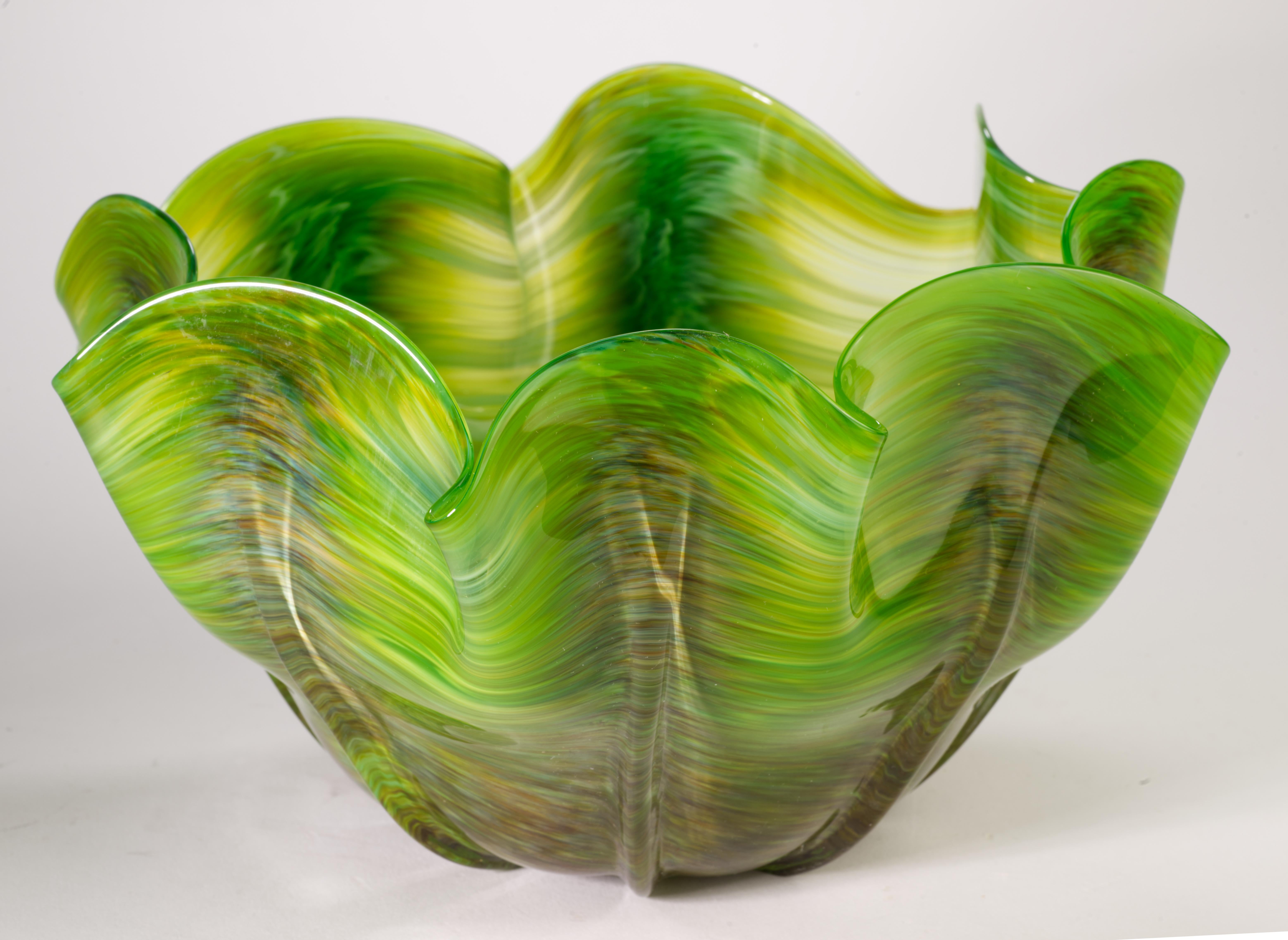  Striking Organic Modern bowl was hand blown with fluid, folded edge. The colored white and brown fused glass elements were placed in abstract, graphic pattern on bright green background, with the whole structure enclosed in clear glass in sommerso