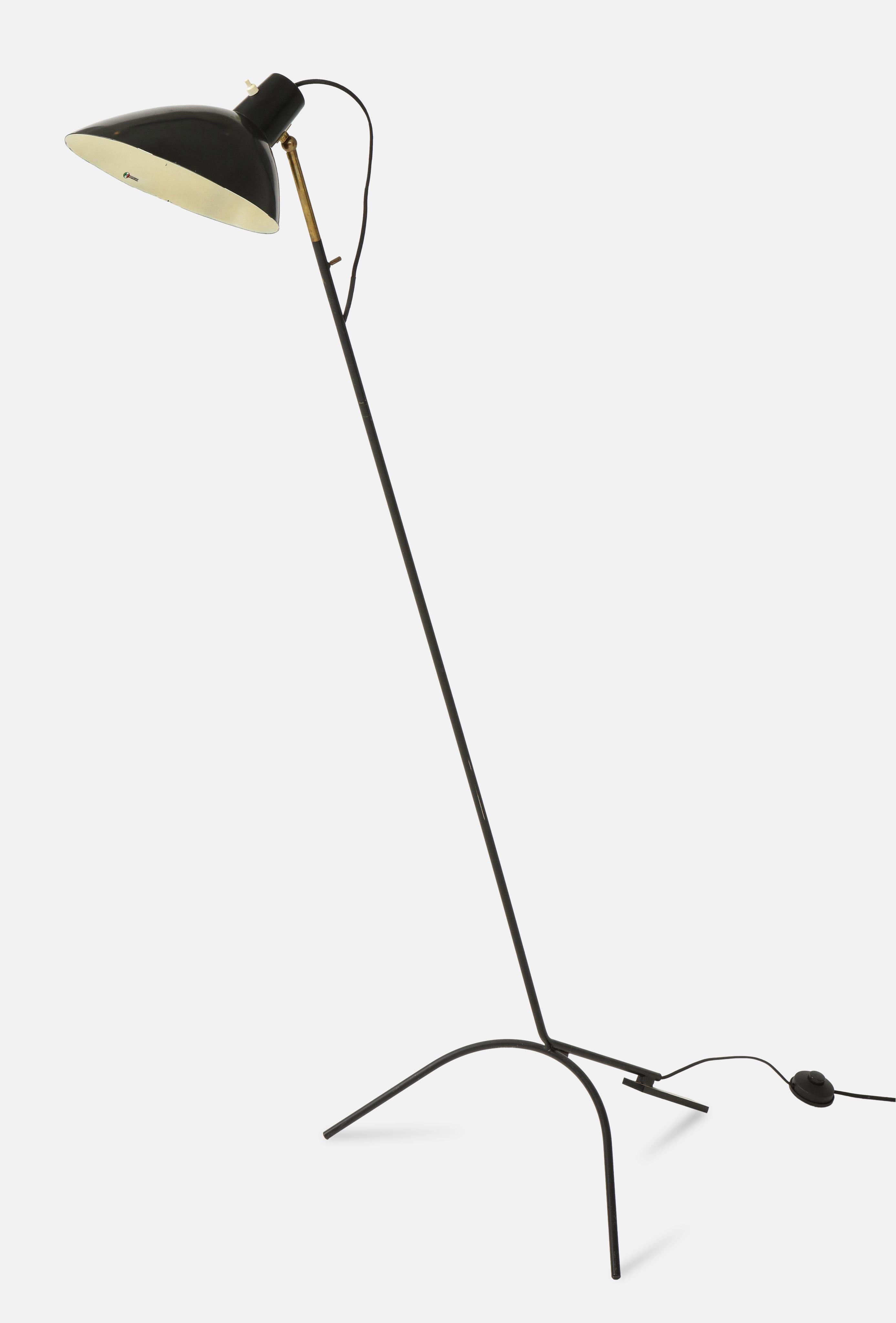 Designed by Vittoriano Vigano and manufactured by Arteluce in Italy, circa 1951, rare and original floor lamp model 1047 with black lacquered aluminum adjustable shade on brass stem and tripod base, with original manufacturer's label inside the