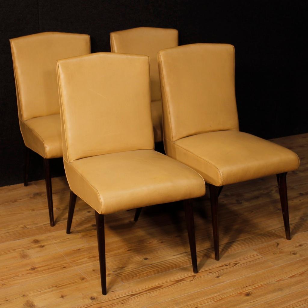 Italian design Vittorio Dassi 4 chairs from the 1950s-1960s. Furniture supported by solid wooden legs and covered in faux leather. Padding in good condition, comfortable chairs, ideal for a living room. The coating has some signs of wear and small