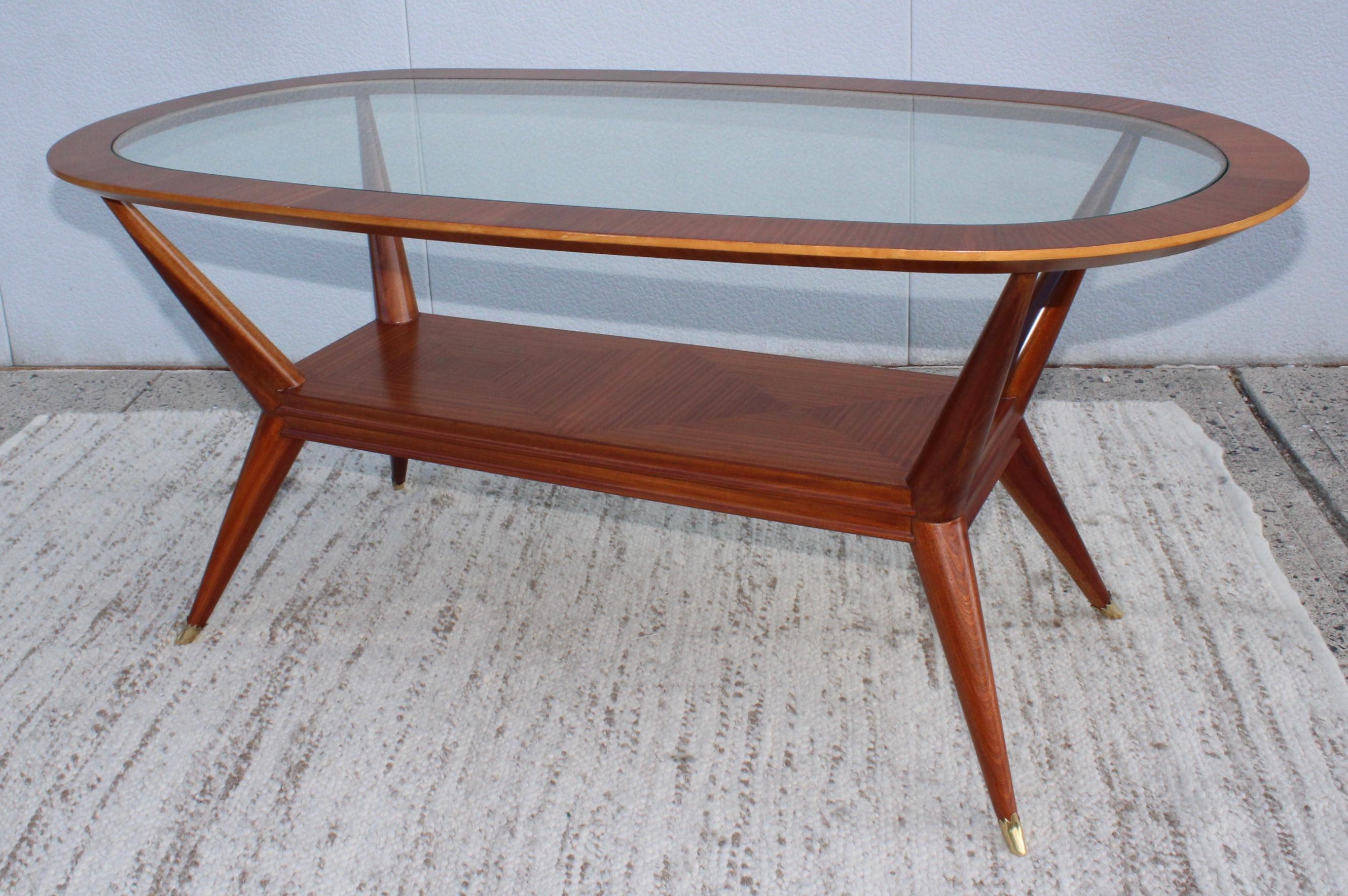 Stunning 1950s Mid-Century Modern Vittorio Dassi attributed sculptural walnut oval dining table/desk with brass sabots, lightly restored with minor wear sand patina.