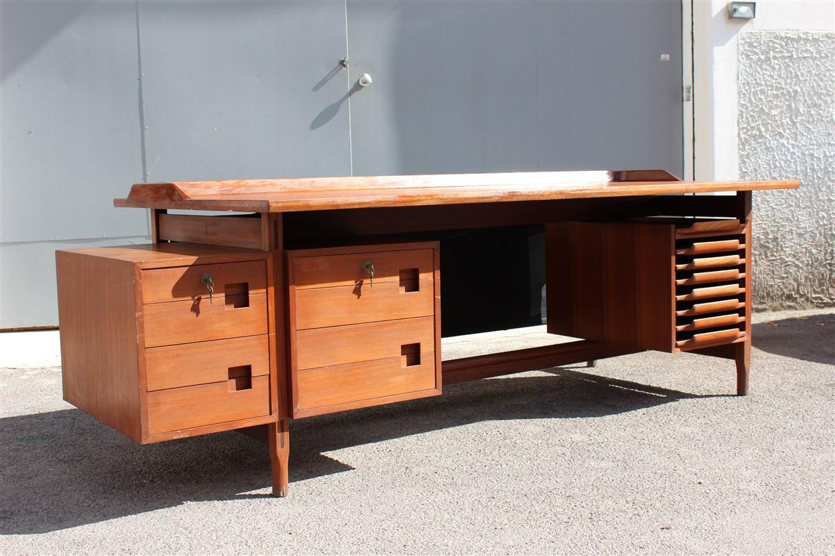 Vittorio Dassi desk Soldi teak midcentury Italian Design 1950 minimal rational shape.

Manufactured and quality desk in solid teak wood, left side 8 drawers with handle embedded in teak,
right side paper mill with document tray, the back side is