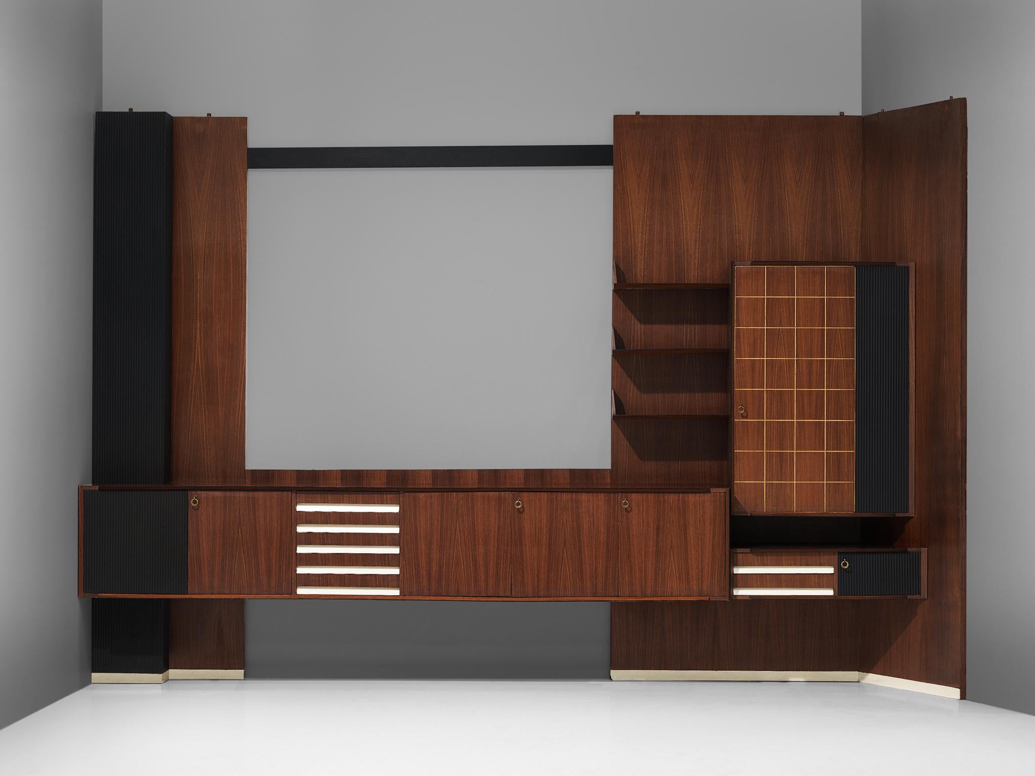 Vittorio Dassi, wall unit, walnut, Italy, 1950s.

A large wall unit in mahogany, designed by Vittorio Dassi. The cabinet is probably costume made and features drawers and several shelves, which offers plenty of storage space. There are different