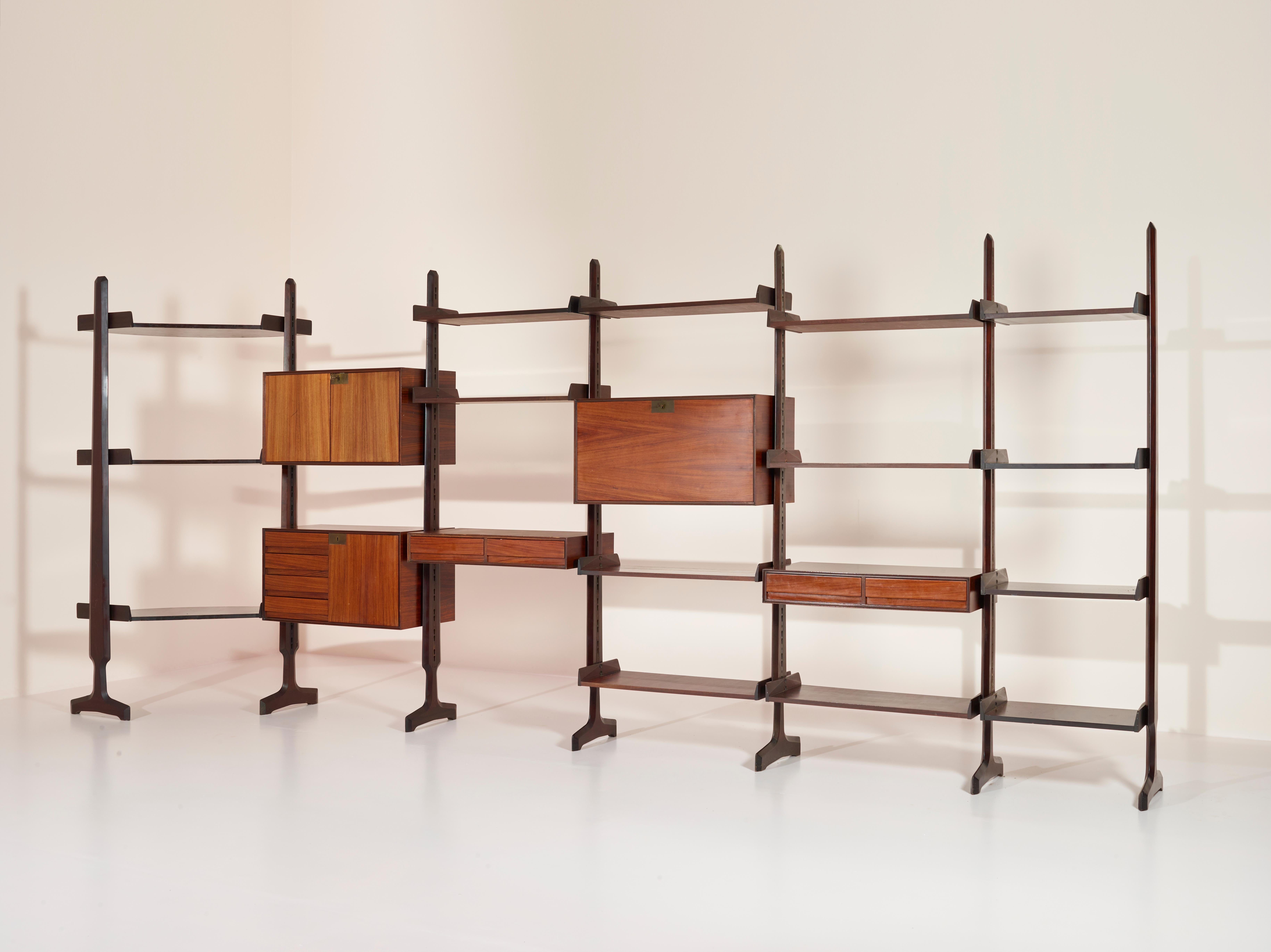 This beautiful and very large freestanding wall unit designed by Edmundo Palutari and produced by Vittorio Dassi during the 1950s, is constructed from high-quality teak and features linear brass detailing that adds a touch of elegance and