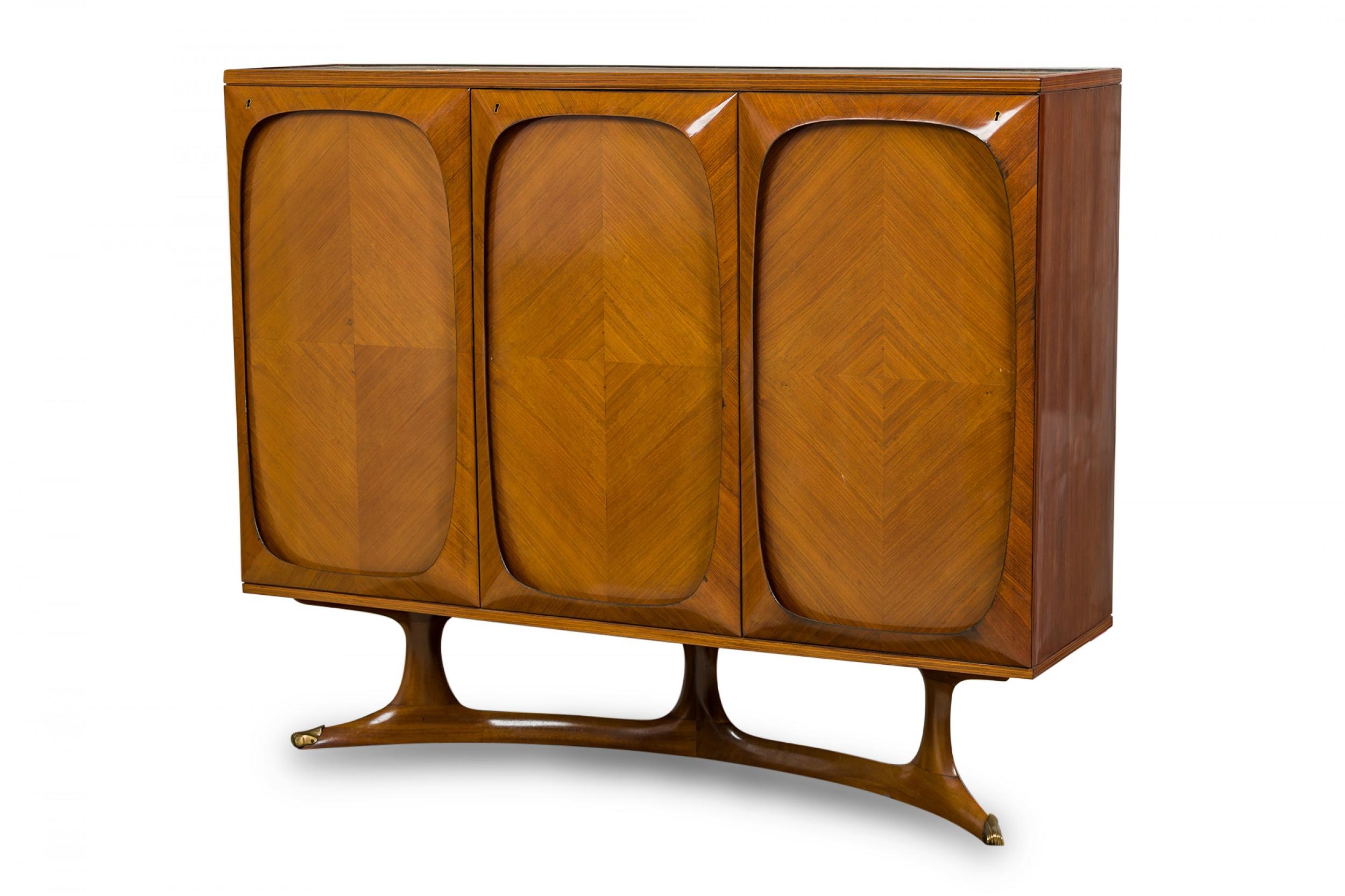 Mid-Century Italian (1950s) credenza / cabinet with a diamond patterned mahogany veneer, with three doors with oval framing that open on a hinge to reveal interior cabinets, resting on on an angle pedestal base (VITTORIO DASSI)
