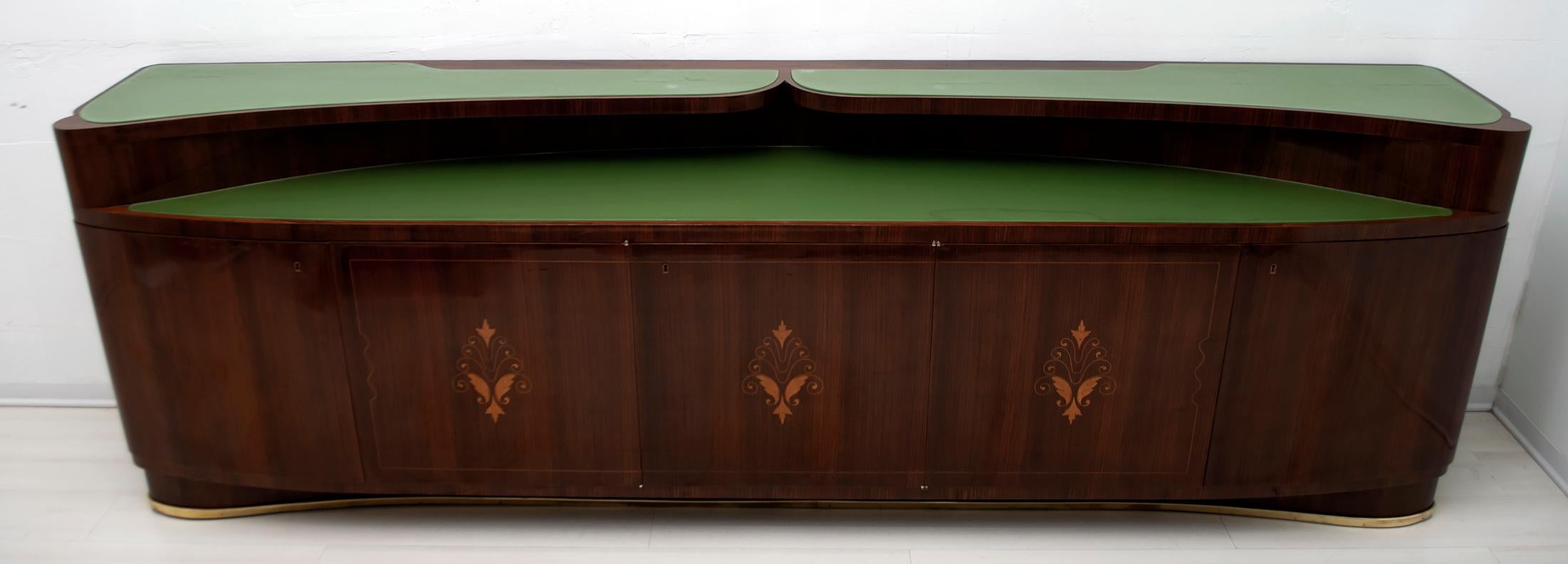 This sideboard was designed by the famous Italian design Vittorio Dassi, produced by the company of the same name: Dassi Lissone Milan, Italy 1950s, the furniture is in rosewood and green glass tops, the rosewood doors show an elegant maple inlay,