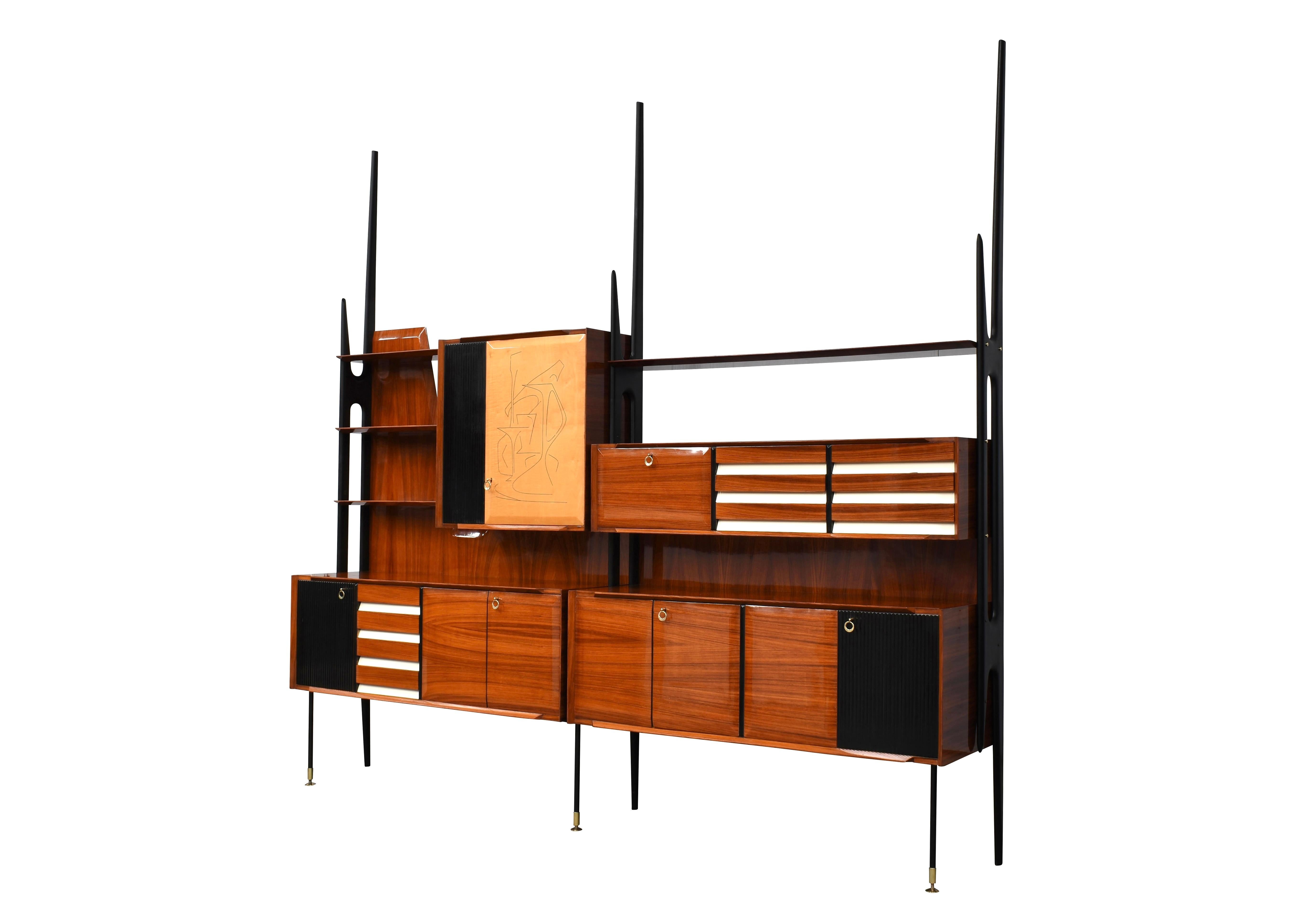 Monumental wall unit by Vittorio Dassi for Mobili Cantù – Italy, circa 1950.
Italian walnut, birch and brass details.
The inside of the cabinets and drawers are covered luxuriously in birch veneer and the shelves are made of birch and some of