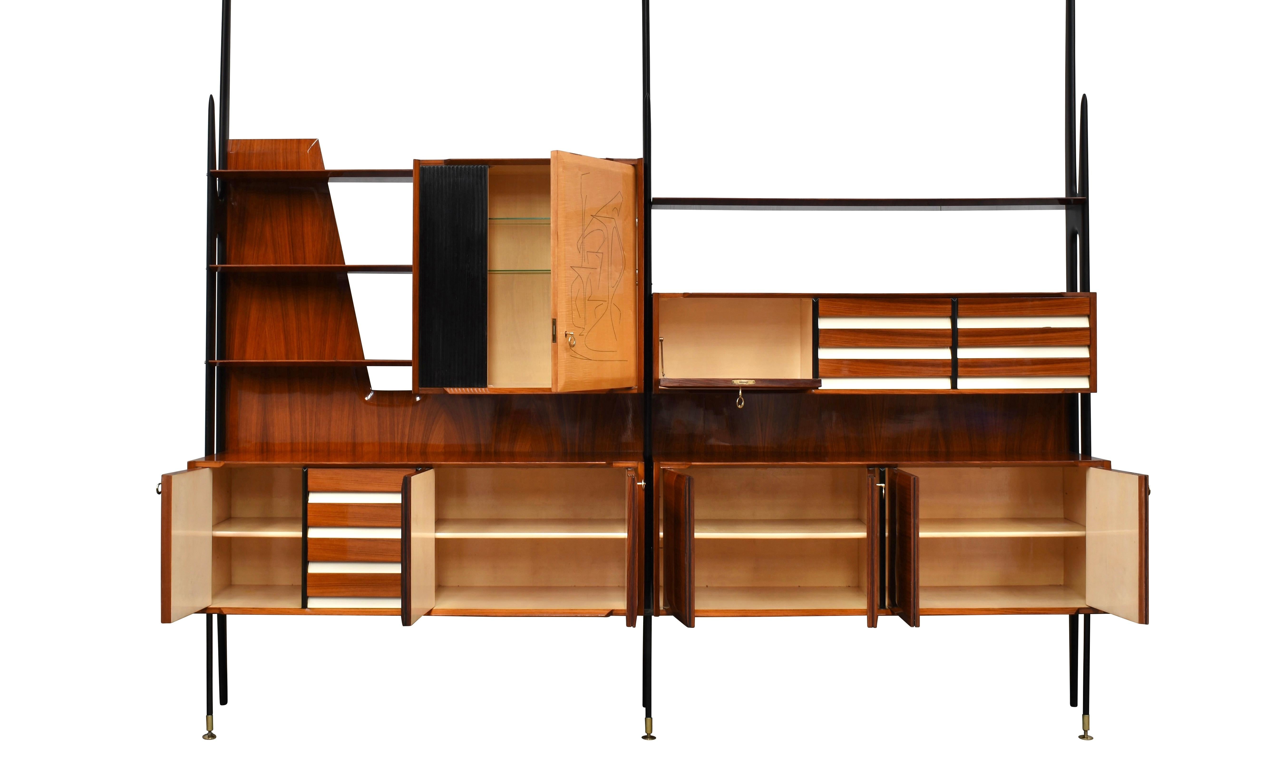 Monumental and very rare wall unit by Vittorio Dassi for Mobili Cantù – Italy, circa 1950.
Italian walnut, birch and brass details.
The inside of the cabinets and drawers are covered luxuriously in birch veneer and the shelves are made of birch and