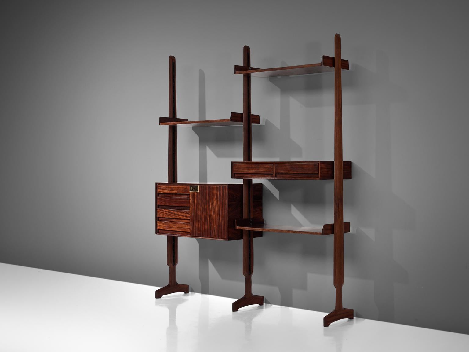 Vittorio Dassi, wall book shelf, in rosewood, Italy, 1960s. 

This book shelf features a three legged structure. This shelving unit is thus three sections large yet the order and lay out of this unit is adjustable and can be placed according to