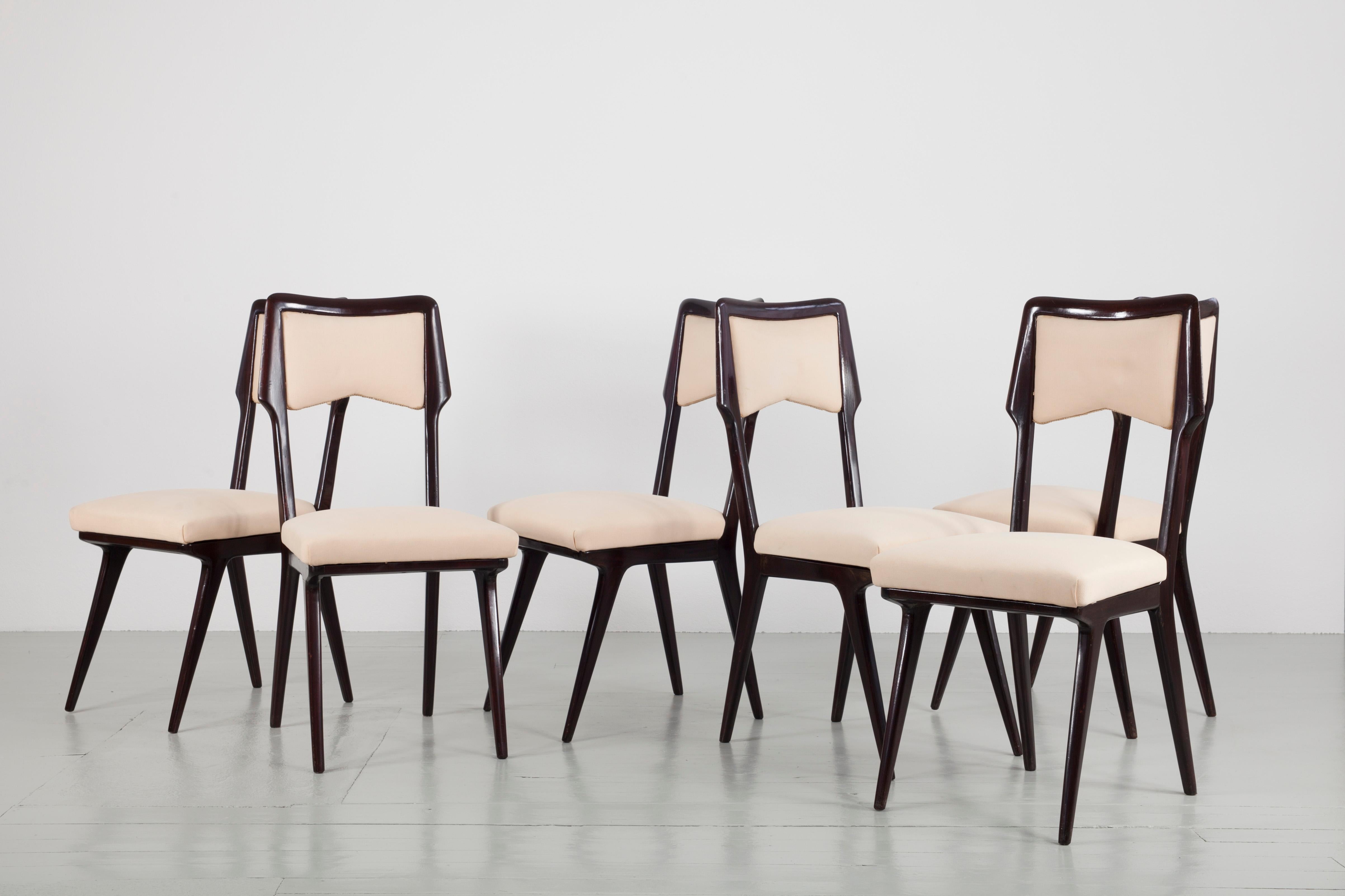 Set of six dining chairs, design by Vittorio Dassi. This elegant dining room set has palisander frames which superbly contrast the cream colored covering of the upholstery.
 
  