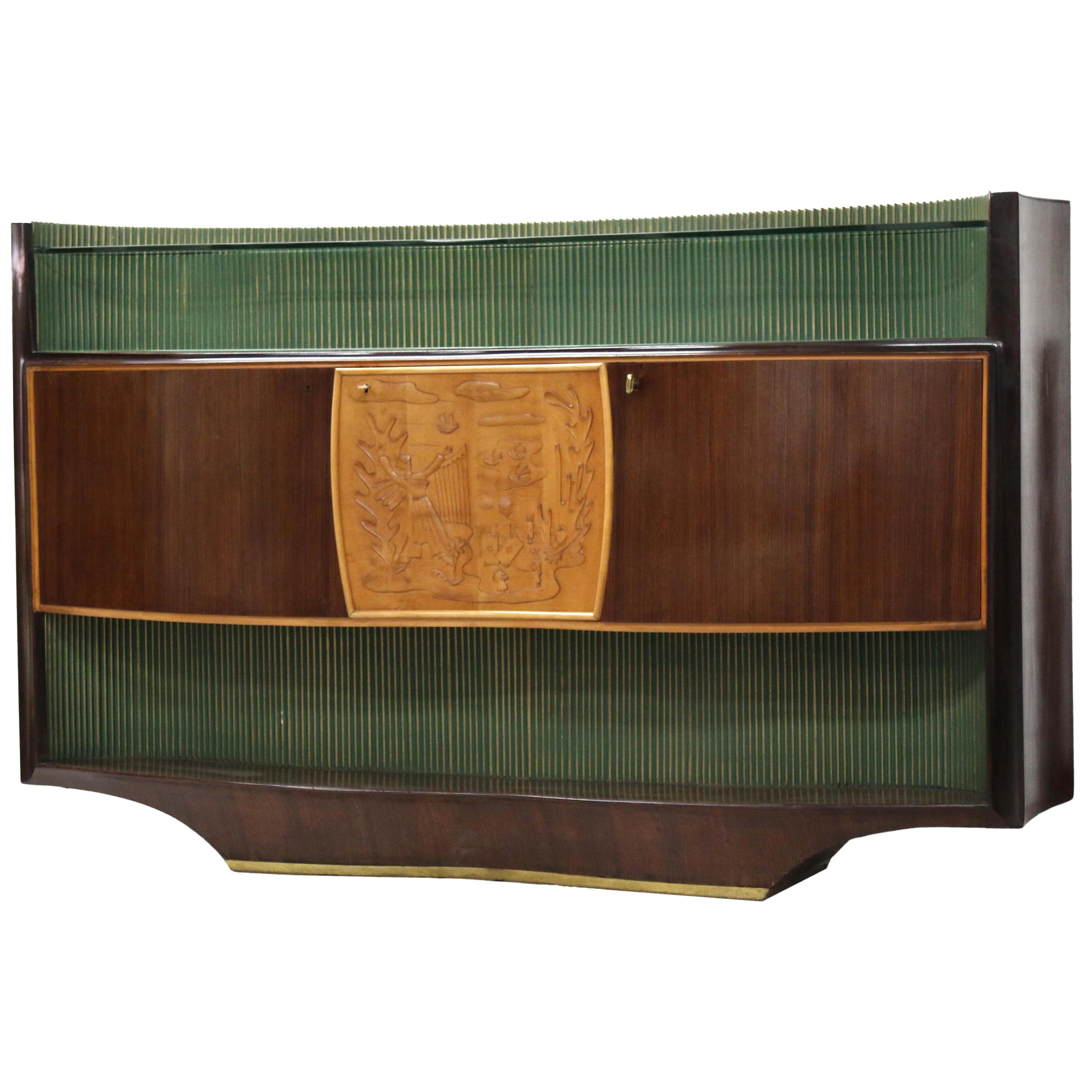 A quality midcentury Italian rosewood and maple credenza, manufactured by the Italian artist Vittorio Dassi, circa 1950s, the serpentine front with a wavy green glass shelf with a reeded green and gilded gold back panel over the central cupboard