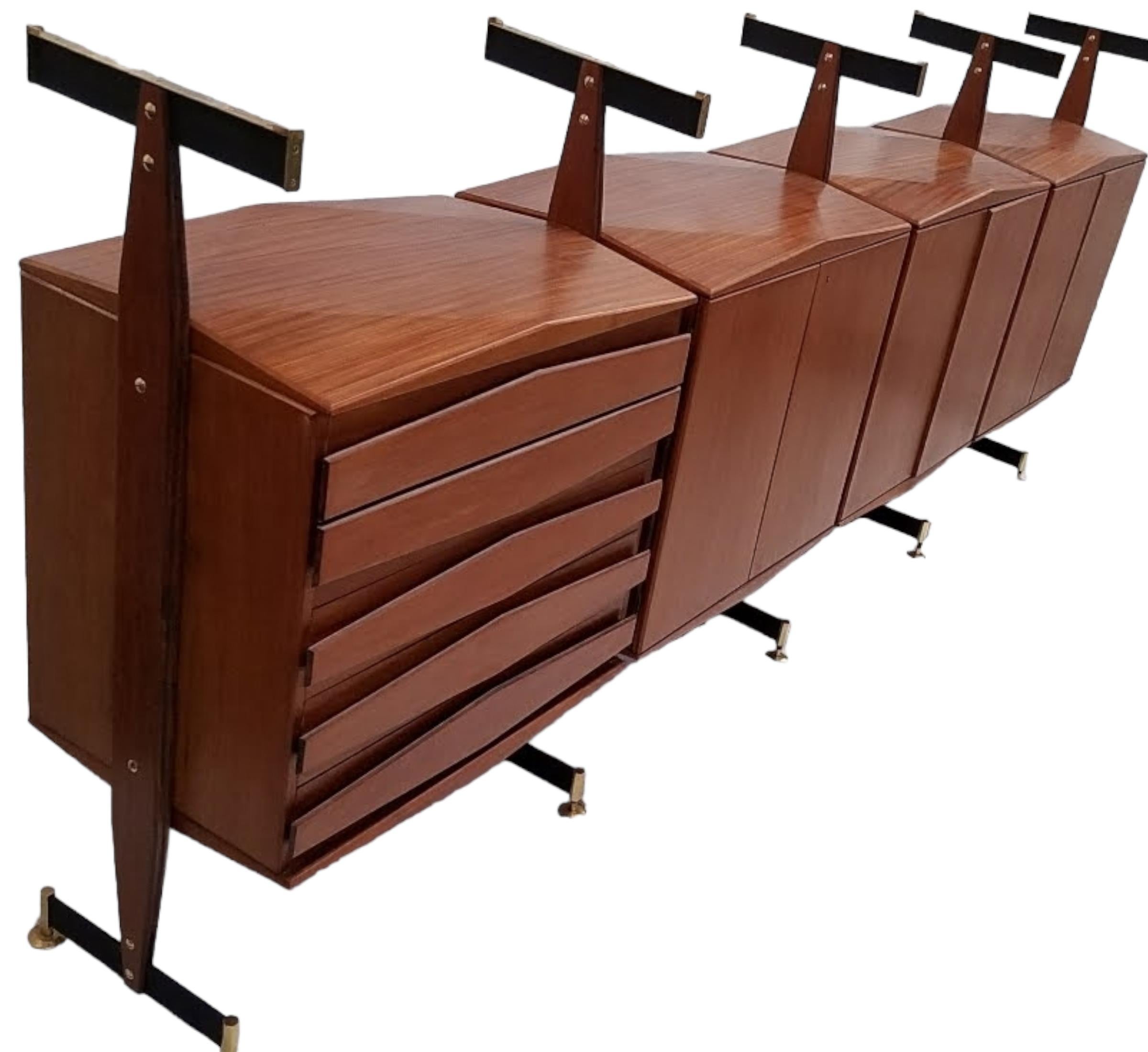 A very rare and sophisticated sideboard by Vittorio Dassi stamped Permanente Mobili Cantu Italy from the 1950s consisting of four suspended cabinets, three of which have locking doors, the fourth has drawers with raised hexagonal pulls.
Each