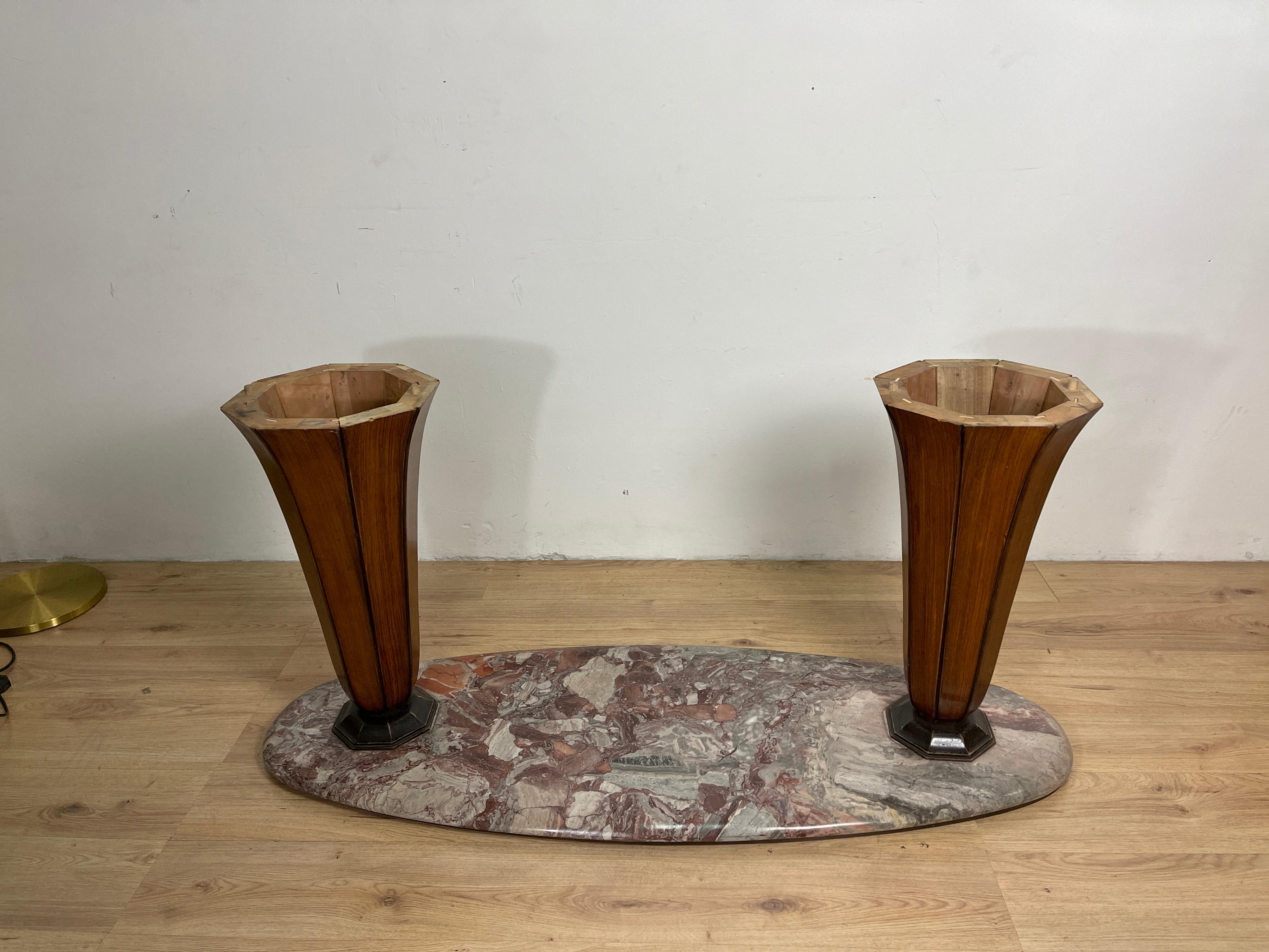 Oval dining table composed of several materials, has a marble base with two octagonal rosewood feet, the top is composed of a frame with a rosewood base finished with an oval top with black glass, the design and construction are work by Vittorio