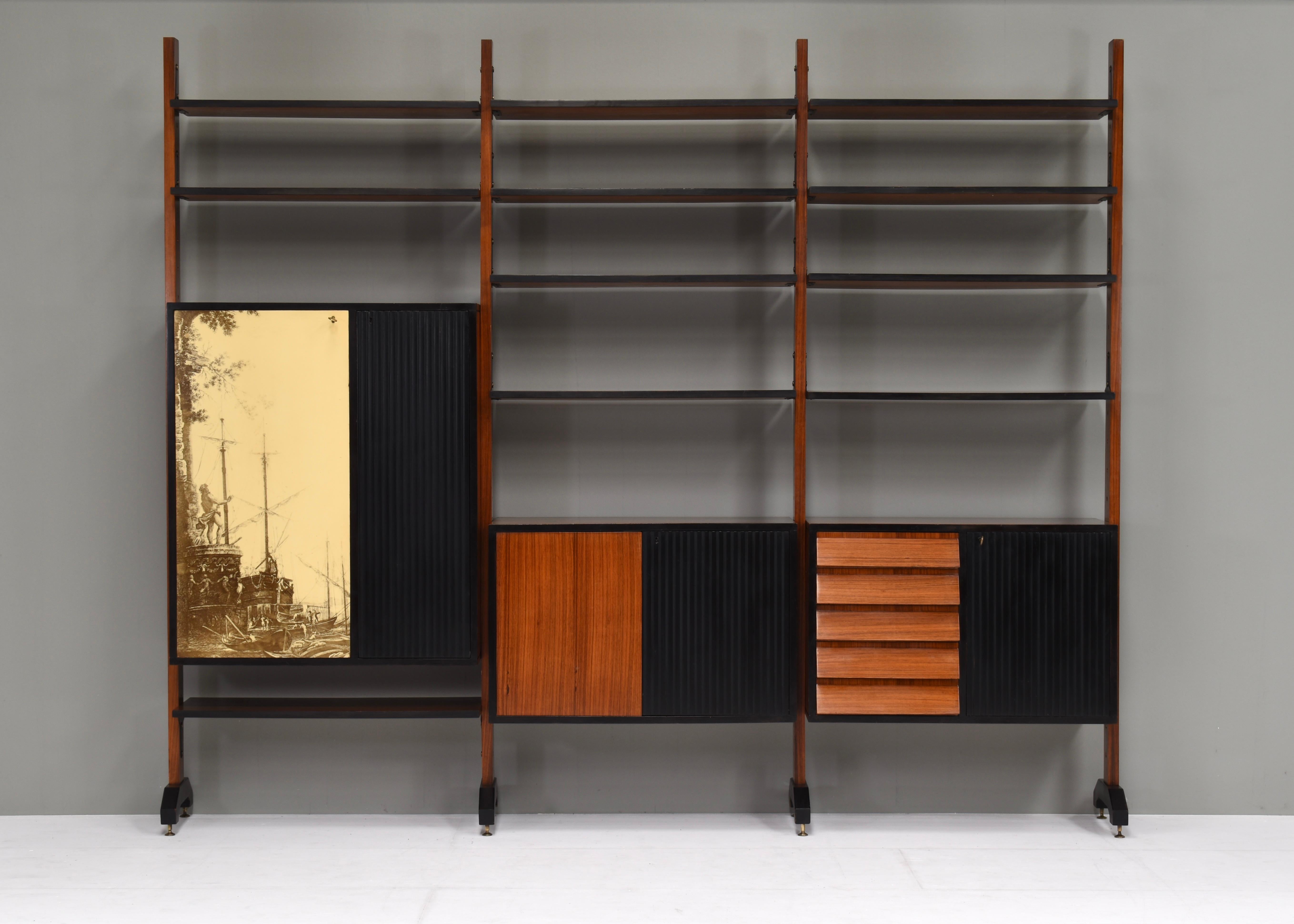 Sophisticated and very rare wall unit by Vittorio Dassi for Mobili Cantù - Italy, circa 1950-60.

The inside of the cabinets and drawers are covered very luxuriously in Birch veneer and red felt. The inside shelves are made of Birch and some of