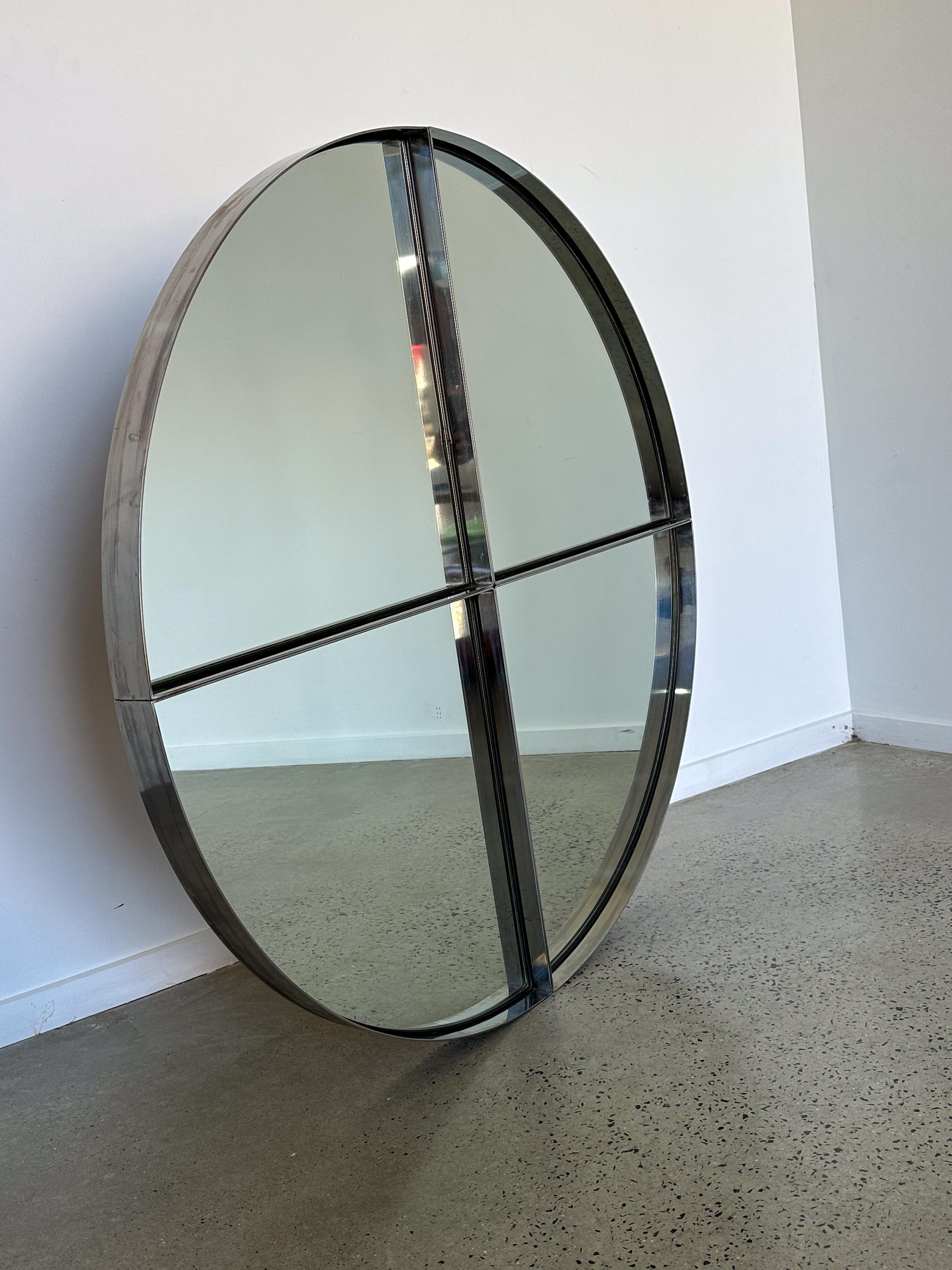 Vittorio Introini for Saporiti Italia large Mid century Modern round wall mirror divided into four segments.

Vittorio Introini (1933-2015) was an Italian architect and designer known for his contributions to modern and contemporary design. He