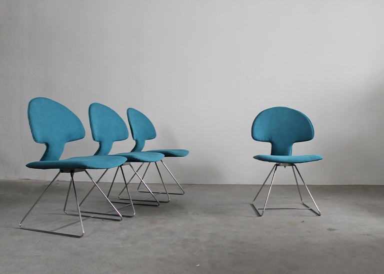 Set of four Longobarda chairs with chromed metal legs, seat, and back upholstered with blue shade fabric.
The Longobarda chair was designed by Vittorio Introini and manufactured by Saporiti in 1960s. 

Vittorio Introini is an Italian designer and
