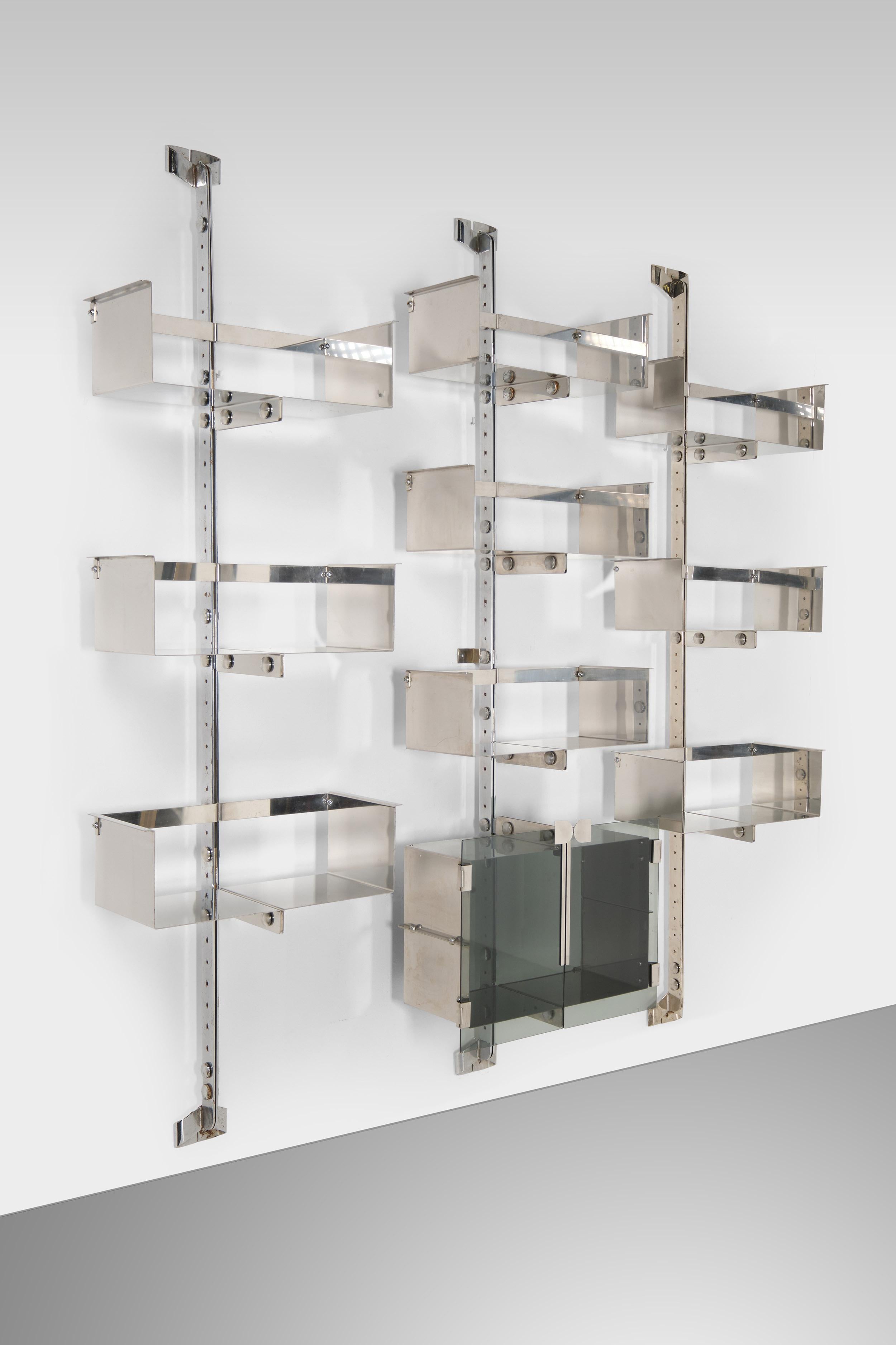 These three model P700 bookshelves were designed by Vittorio Introini for Saportiti's Proposal series. Lightness and elegance are the keywords for these amazing items, made out of chromed metal and mirrored steel. The glass shutters add an extra