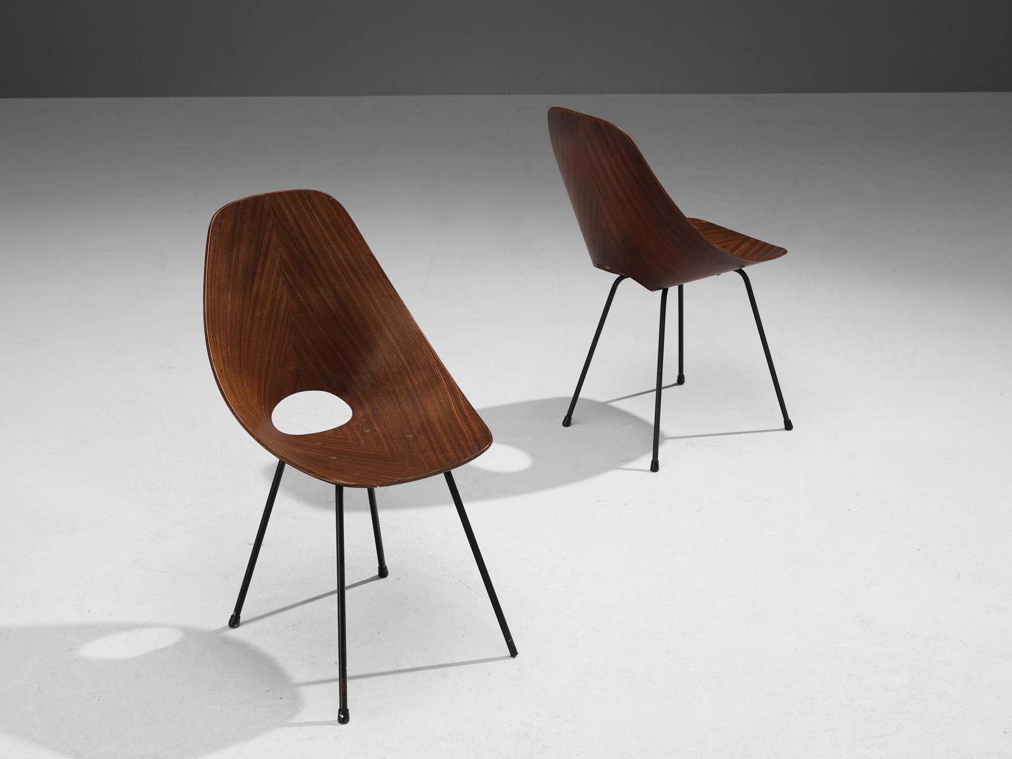 Vittorio Nobili for Tagliabue, dining chairs model 'Medea', mahogany, metal, brass, Italy, 1955.

This 'Medea' chair is designed by the Italian designer Vittorio Nobili. The plywood chairs are veneered in carefully chosen mahogany, which gives them