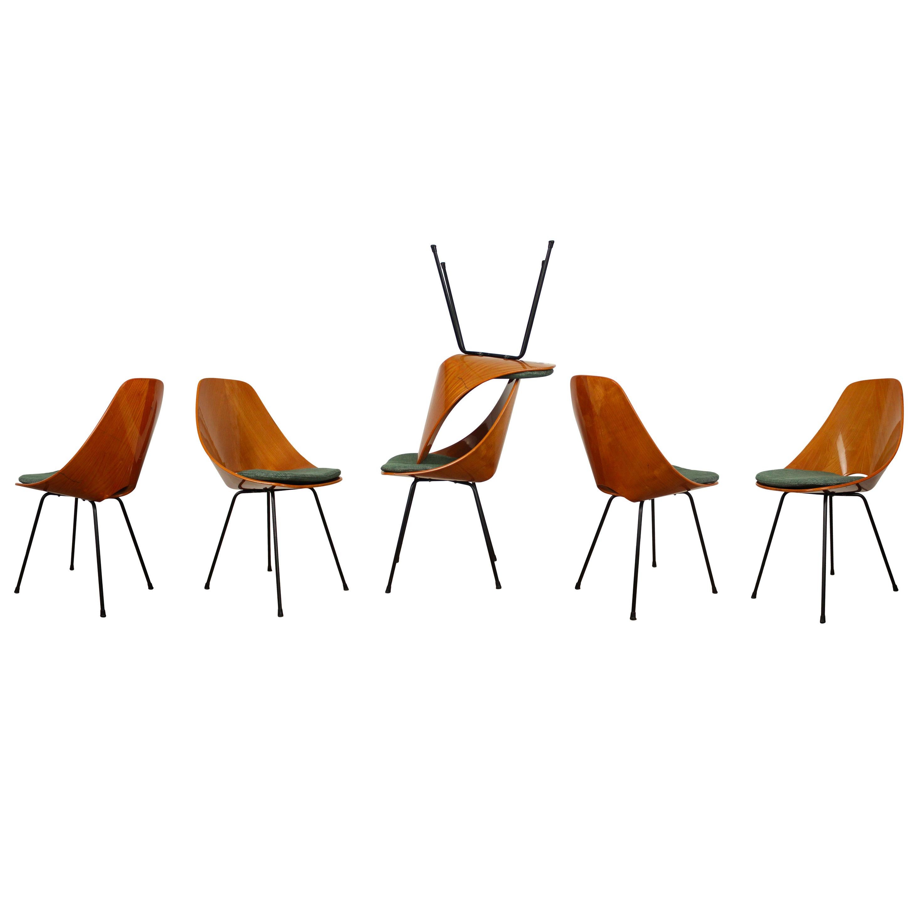 Set of Six Medea Chairs Designed by Vittorio Nobili for Fratelli Tagliabue, 1956

This set of six Medea dining chairs features:
- Elegant beech plywood shell construction
- Sculptural, ergonomic seat design
- Accompanied by green canvas cushions for