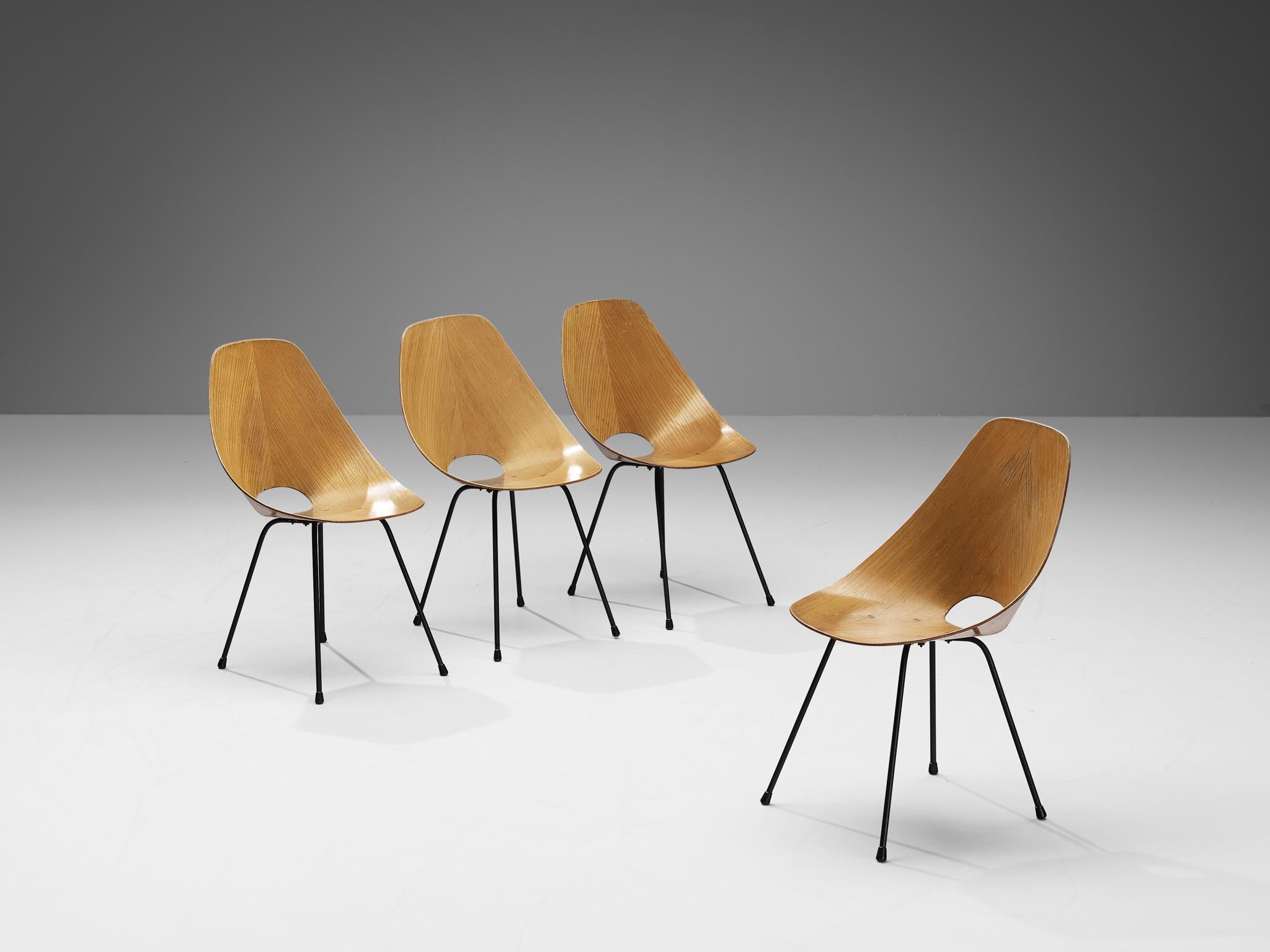 Vittorio Nobili for Tagliabue, set of four dining chairs model 'Medea', ash, metal, brass, Italy, 1955.

This 'Medea' chair is designed by the Italian designer Vittorio Nobili. The plywood chairs are veneered in carefully chosen ash, which gives