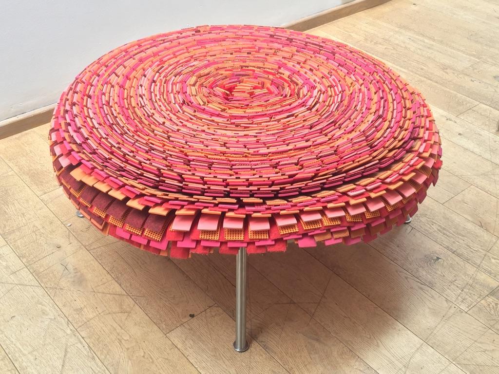 Humberto and Fernando Campana, Brazil.
Large, circular stool formed from strips of orange and pink ethylene vinyl acetate, rubber and fabric 'petals' on splayed cylindrical aluminium supports.
Metal studio tag on the underside stamped 'Estudio