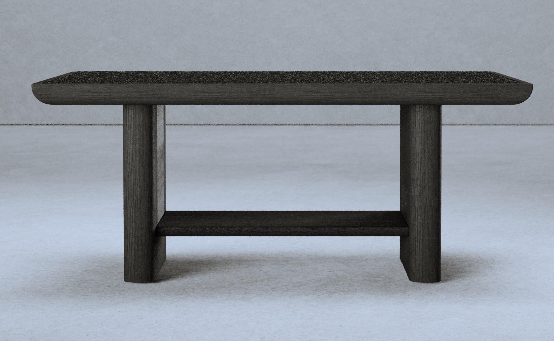 Vittorio Side Table by Gio Pagani
Dimensions: D 55 x W 90 x H 38.5 cm.
Materials: Black ash wood and Loro Piana wool.

In a fluid society capable of mixing infinite social and cultural varieties, the nostalgic search for reworked aesthetics that