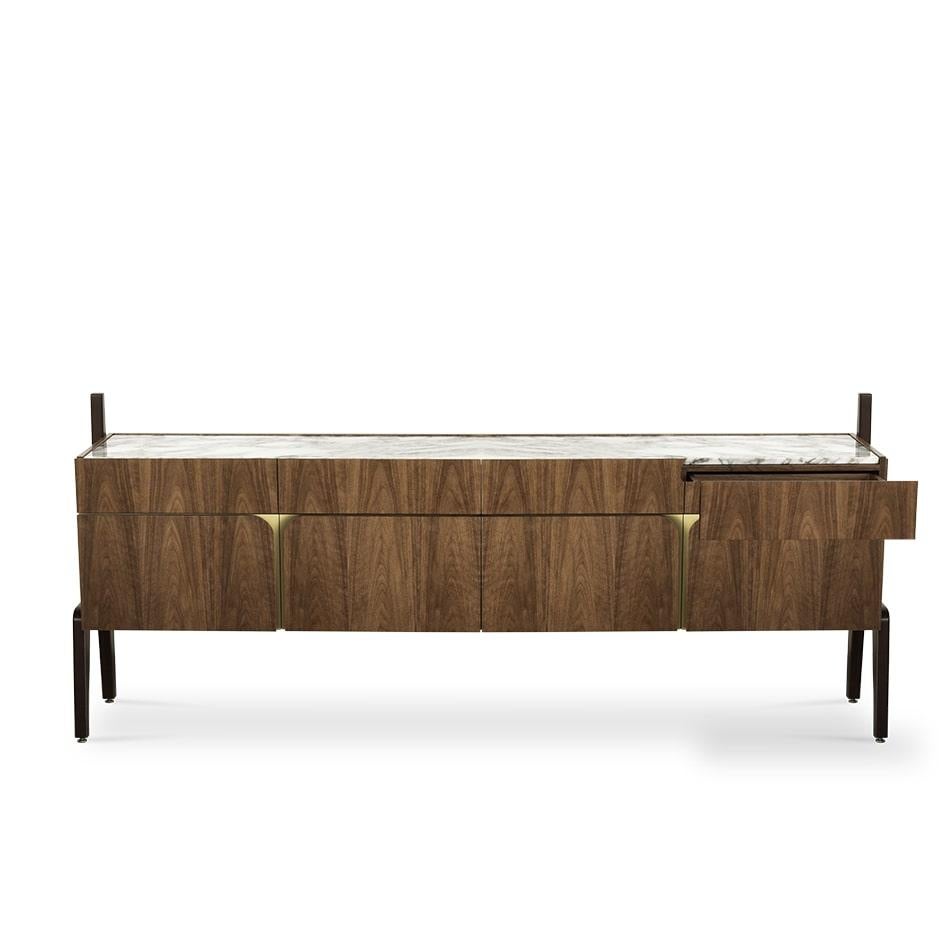 These same curvilinear lines are found in the sophisticated design of the Vittorio sideboard, named after the great Vittorio Gassman.
The combination of the wooden black lacquered H-shaped legs with a walnut wood body and
recessed golden handles,