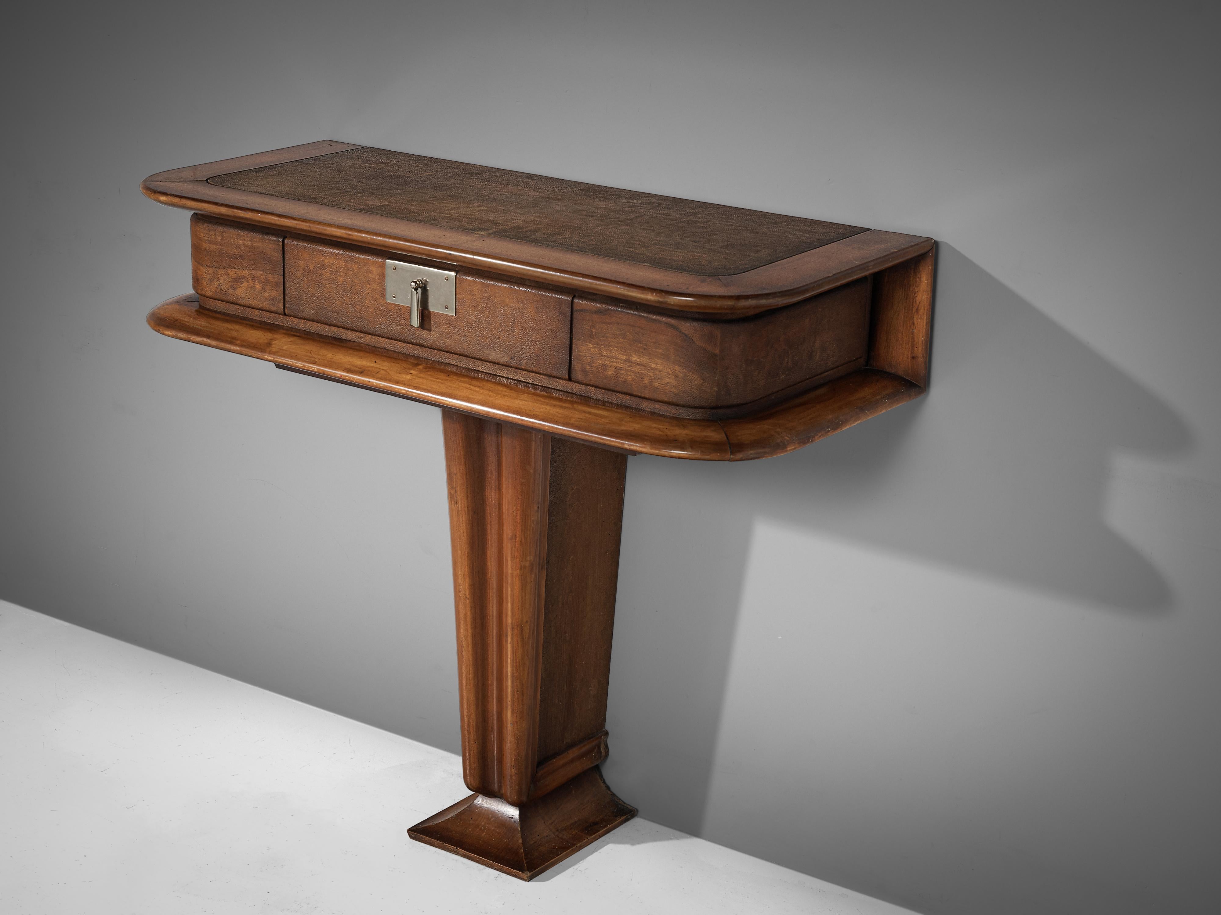 Vittorio Valabrega, console with drawer, walnut, leather, metal, Italy, 1940s

This console by the Italian designer Vittorio Valabrega is sculptural and elegant. Note the details in the base or the fine lines that surround the drawer. A metal handle