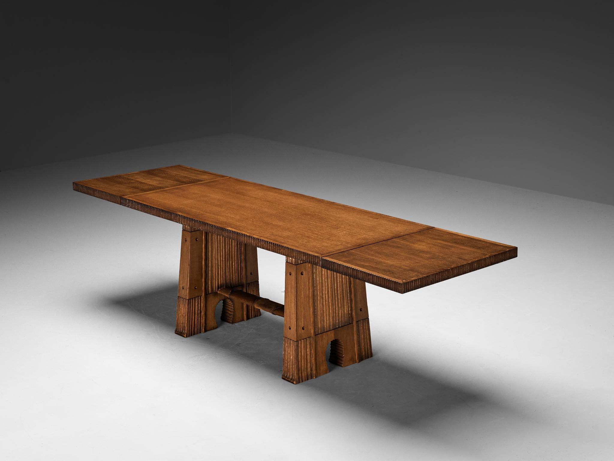 Vittorio Valabrega, extendable dining table, oak, leather, iron, Italy, circa 1935 

Vittorio Valabrega once again proves his great eye for materialization and great craftsmanship this dining table is exemplary for. The table is architecturally