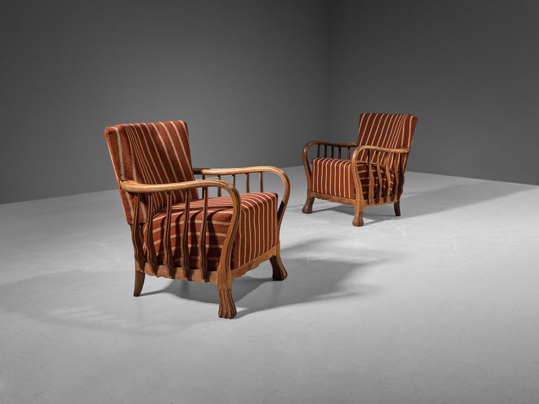 Vittorio Valabrega, pair of armchairs, oak, fabric, Italy, 1920s

This eccentric pair of lounge chairs embodies a splendid construction of subtle lines and curvaceous shapes. Remarkable detail and the signature for this design are the armrests