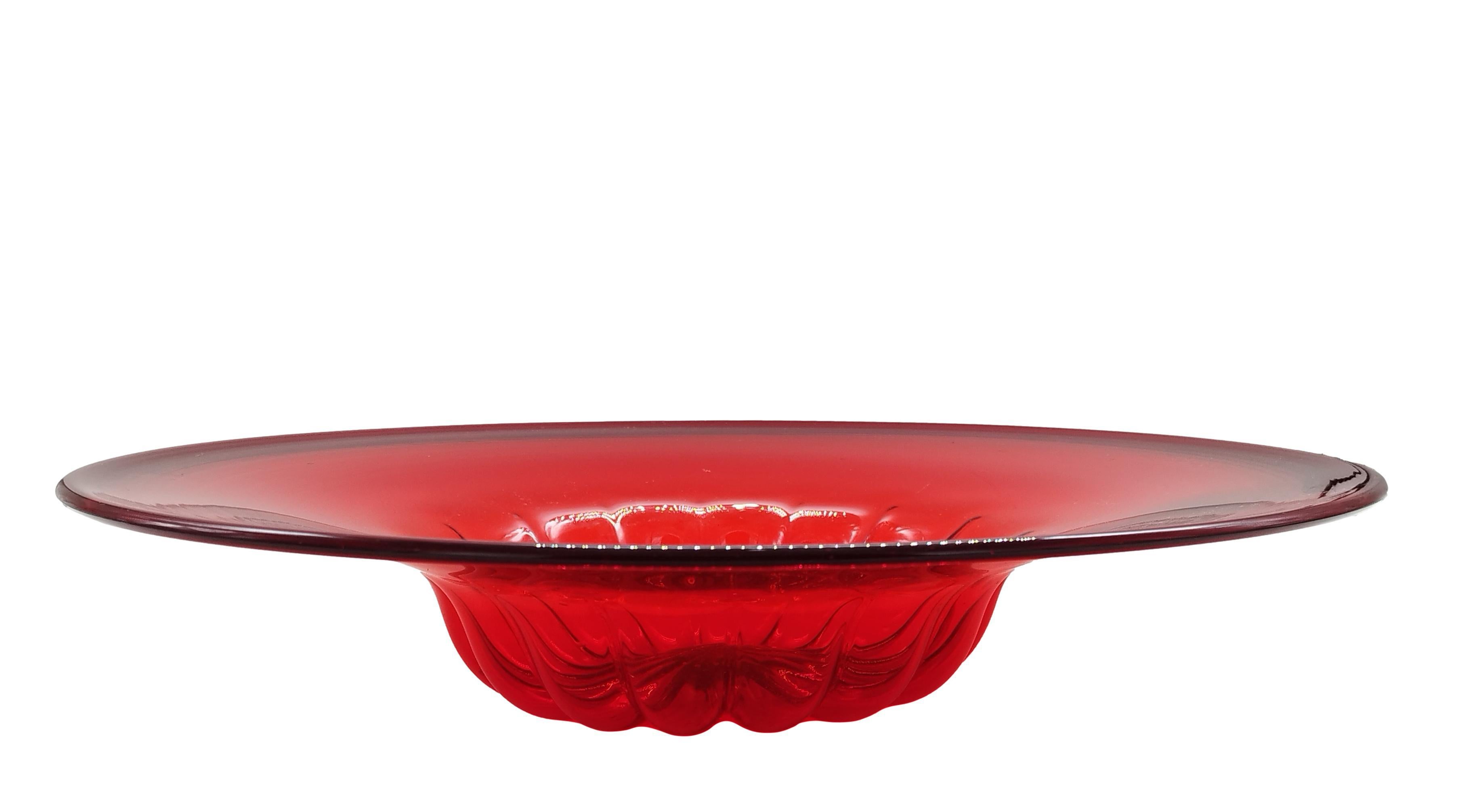 An exceptional large dish in ruby red blown glass, set inside a wrought iron frame, forged in the shape of flowers and leaves. The body of the dish internally is ribbed, the brim with an enchanting vibrant pattern characteristic of Master Zecchin's