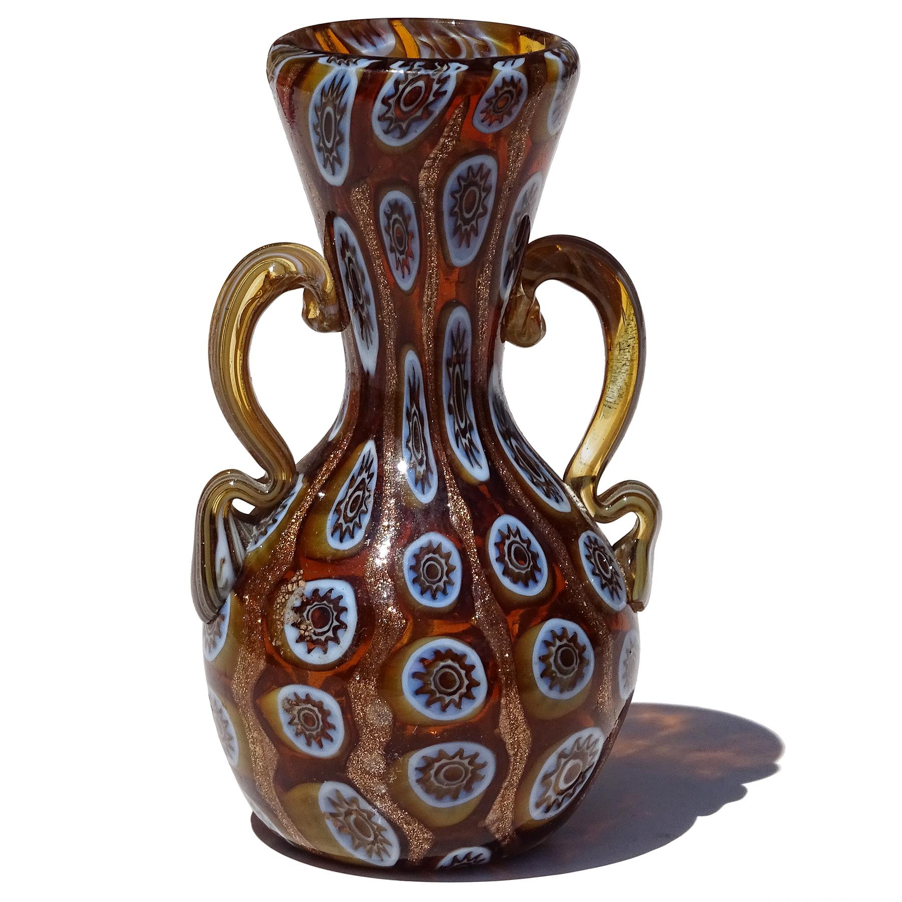 Beautiful and rare, antique Murano hand blown millefiori flower mosaic and aventurine flecks Italian art glass decorative double handles cabinet vase. Documented to the Vittorio Zuffi & C. workshop, circa 1895. The vase has an early shape, created