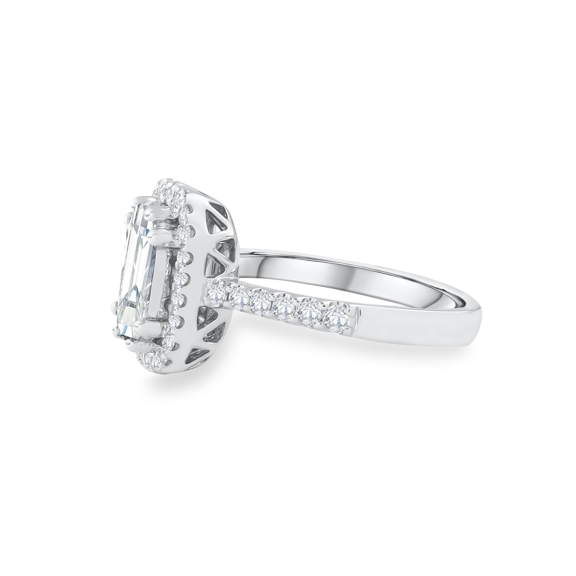 This diamond ring has an Emerald shape Illusion (Pie Cut) to create the look of a 2 carat single Emerald-cut stone surrounded beautifully with brilliant round diamonds, Handcrafted in 18 kt white gold. This Ring will add a touch of sophistication to