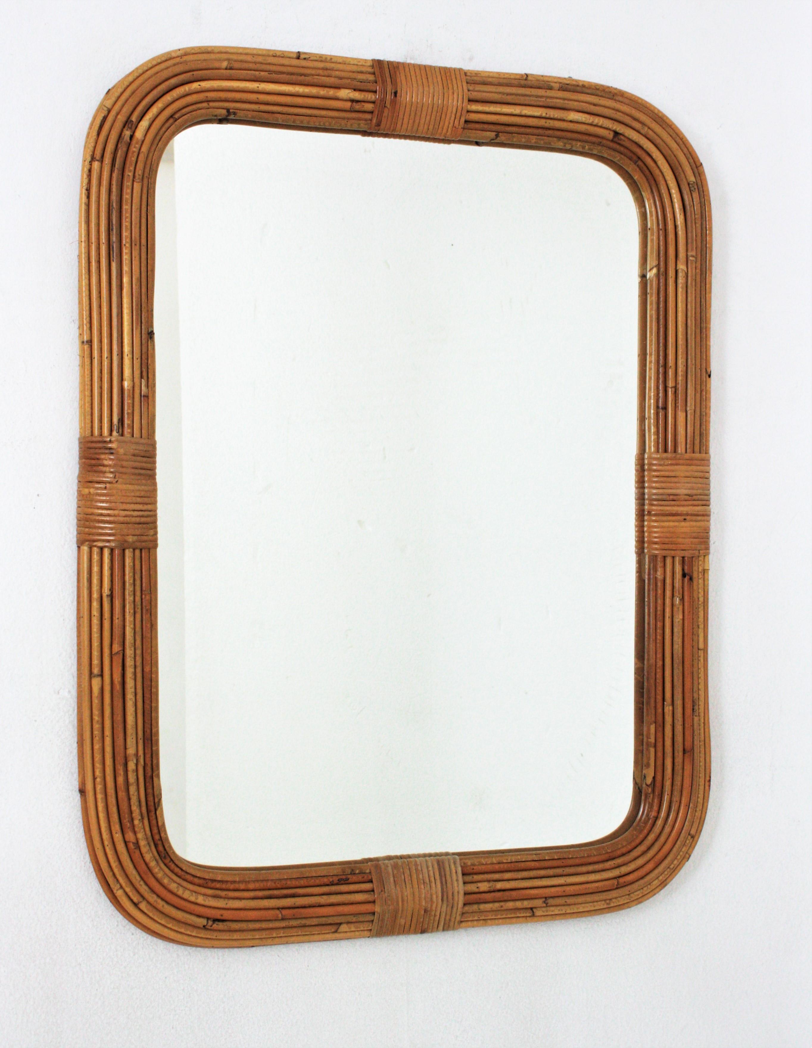 Eye-caching Organic Modern handcrafted in rattan. Attributed to Vivai del Sud. Italy, 1960s.
This mirror features a finely executed rectngular frame made of 9 layers of rattan canes. It has wicker tied details on each side.
To be used as wall