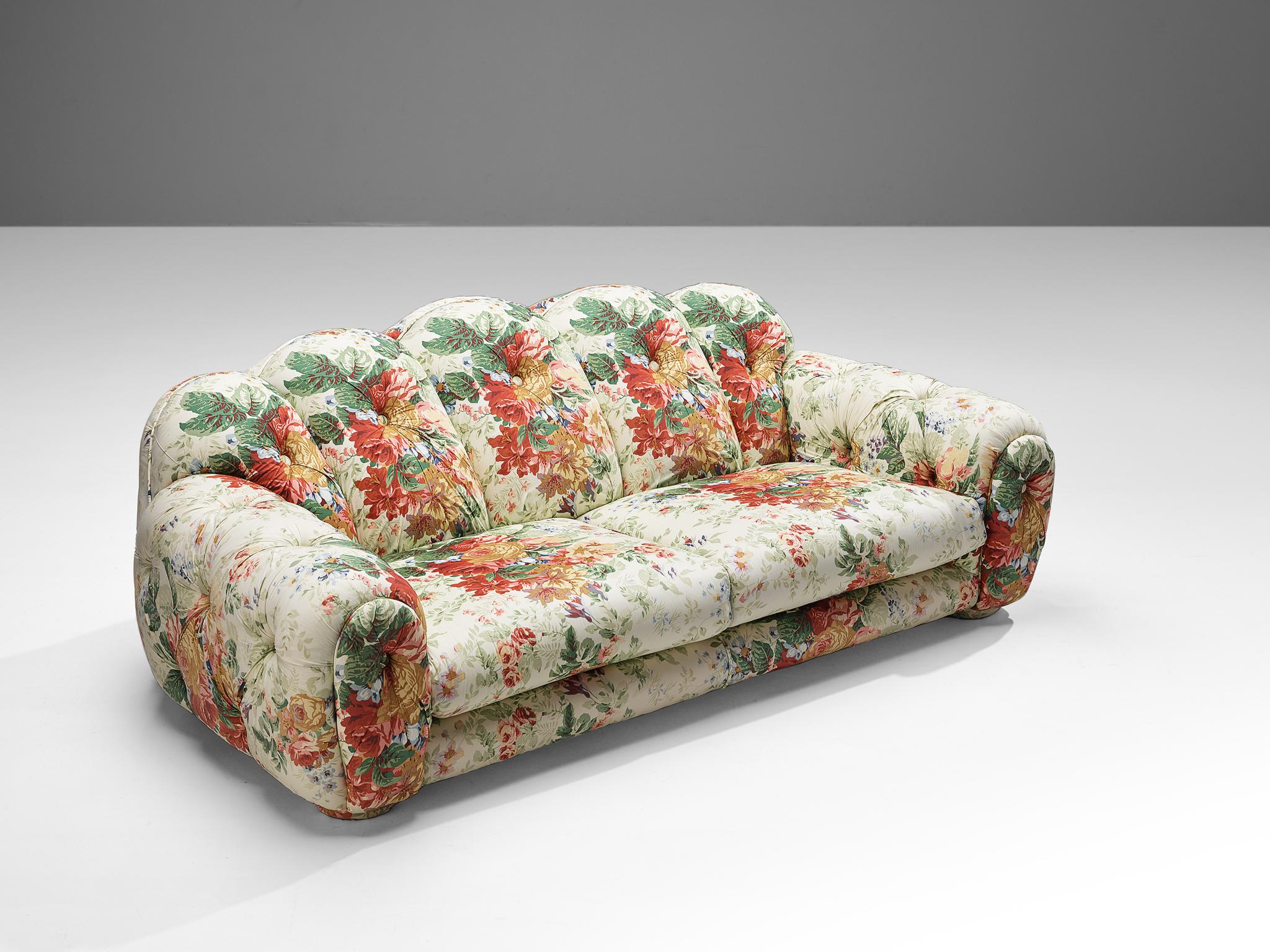 Vivai del Sud, sofa, fabric upholstery, Italy, 1970s 

This vibrant and bulky sofa was manufactured in Italy in the 1970s. This item is upholstered in a multi tone tufted floral fabric. The smooth and bulky form, combined with the floral upholstery,