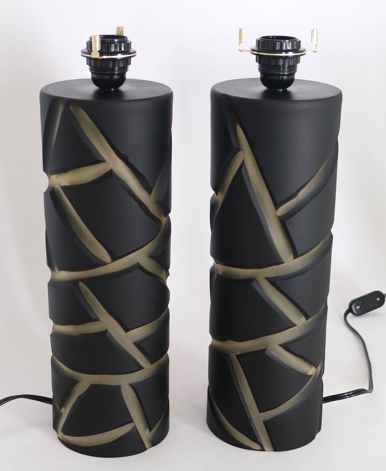 Vivarini table lamps in Murano glass for Formia. Cylindrical in black and clear glass deep cut into giraffe pattern. The pair are signed and dated on the top. Silk paper shades included. These lamps have never been used and are in excellent