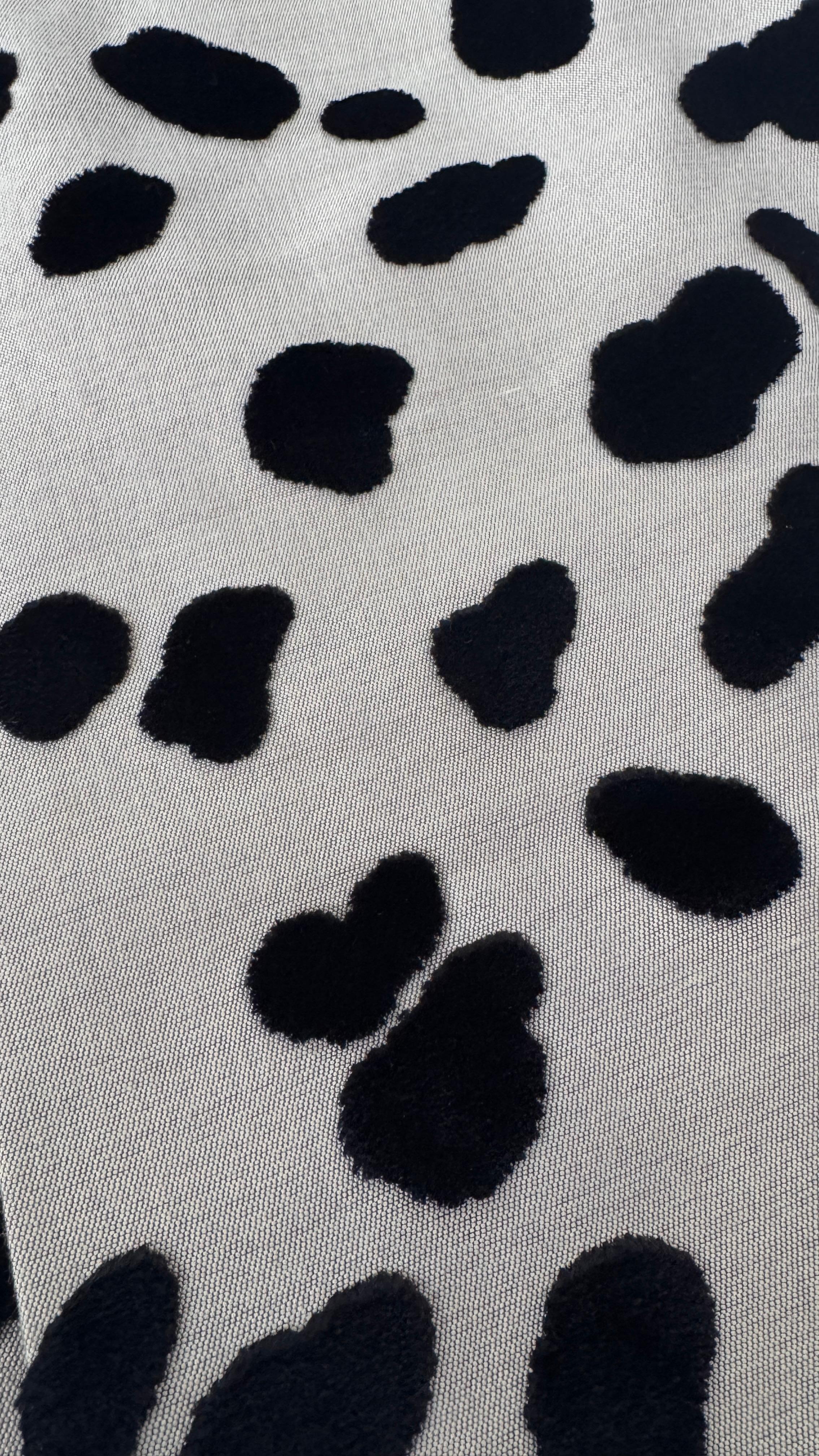 Unleash your wild side with this striking Vivetta midi pencil skirt, crafted in Italy with the brand's signature playful yet sophisticated touch. The skirt features an eye-catching leopard print in plush black velvet flocking, set against a neutral