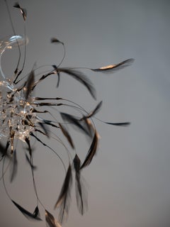 Feather and Glass Installation Artwork “Suspended Whispers” by Vivian Alarcón