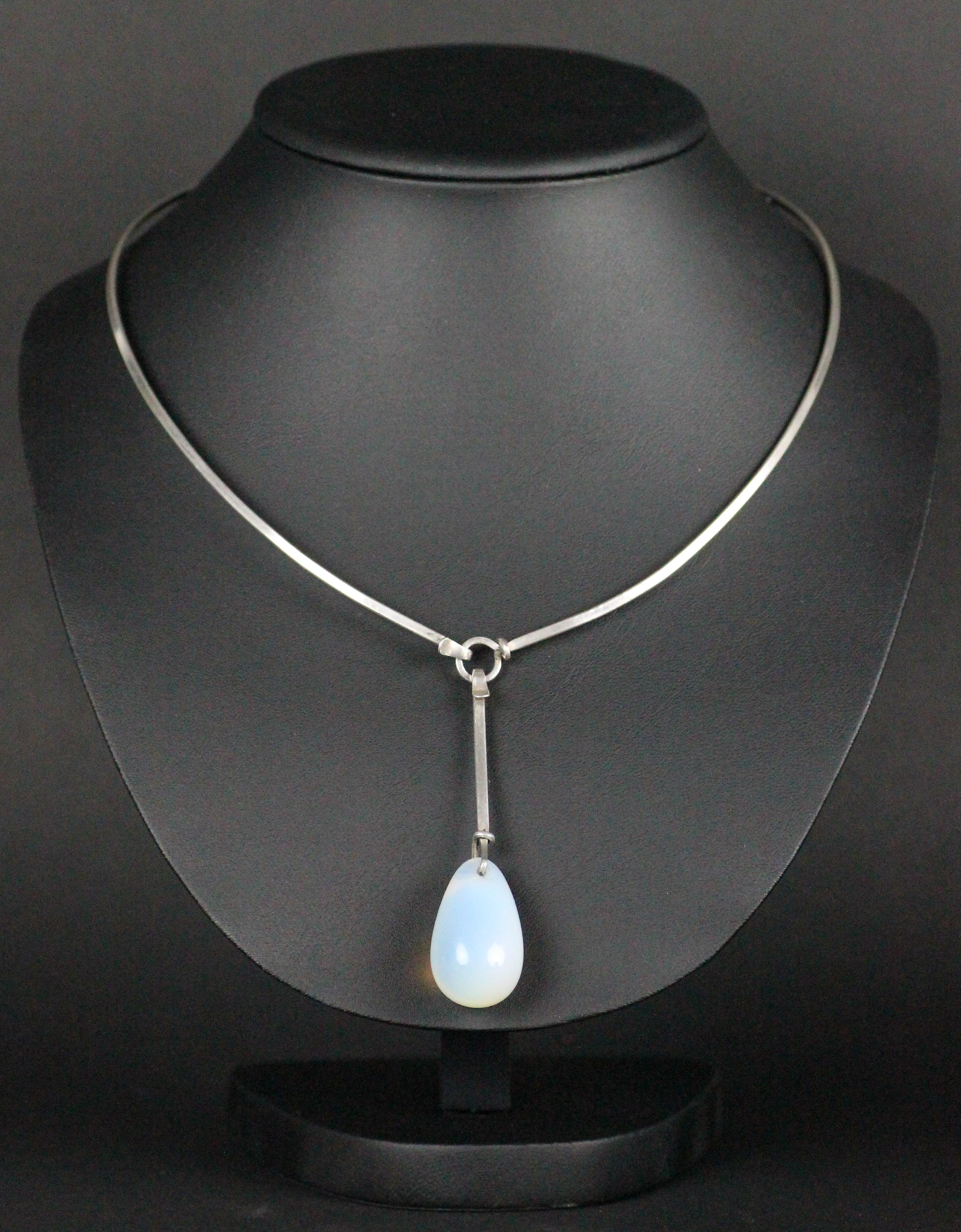 This necklace is made by her self in her own workshop way before she made these for Georg Jensen.  This was bought in France in 1955 so it is most certainly made in 1954-55. Made with silver and a moonstone drop pendant. Both parts are marked
