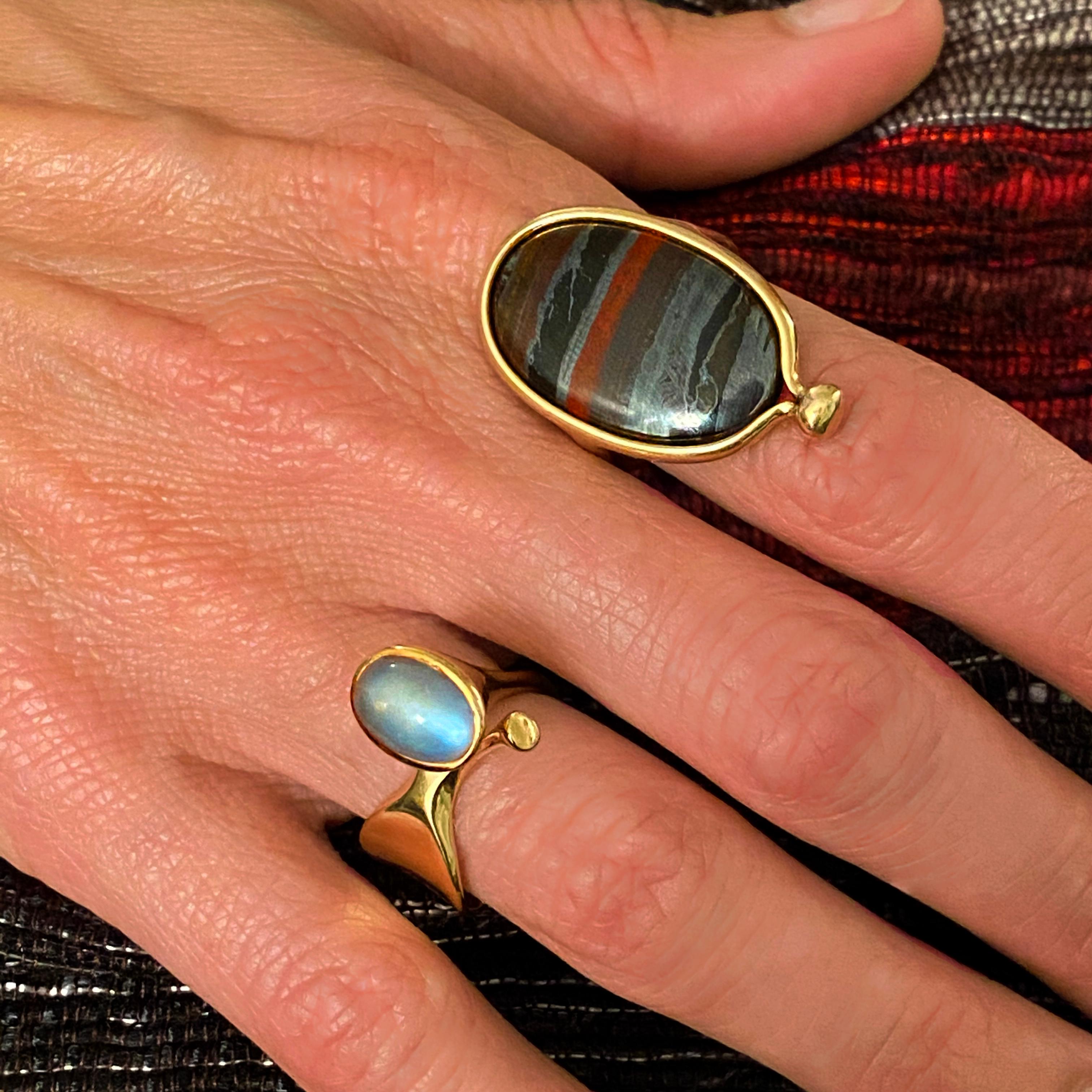 A cat's eye moonstone and 18 karat gold ring, by Vivianna Torun for Georg Jensen, 1960s. The ring is stamped Georg Jensen 18K 750 Torun 915 Denmark. Size 6.50. 

Vivianna Torun was a Swedish silversmith and master jeweler, known for her exquisite