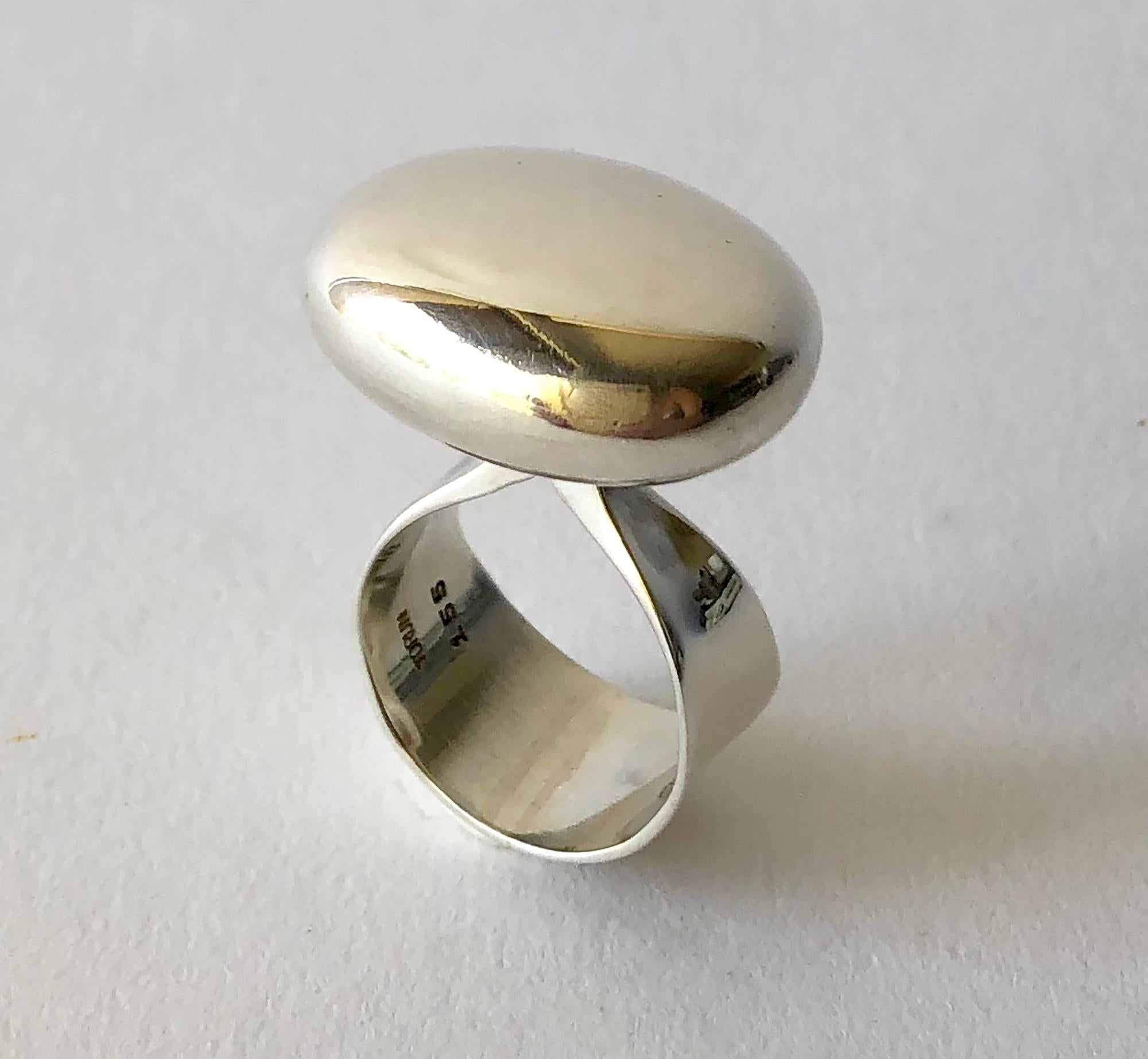 Mirror polish sterling silver ring designed by Vivianna Torun Bulow-Hube for Georg Jensen, circa 1970's.  Ring is a finger size 8 and is signed with the Jensen dotted hallmark, Torun, Denmark, 155.  In very good vintage condition showing wear