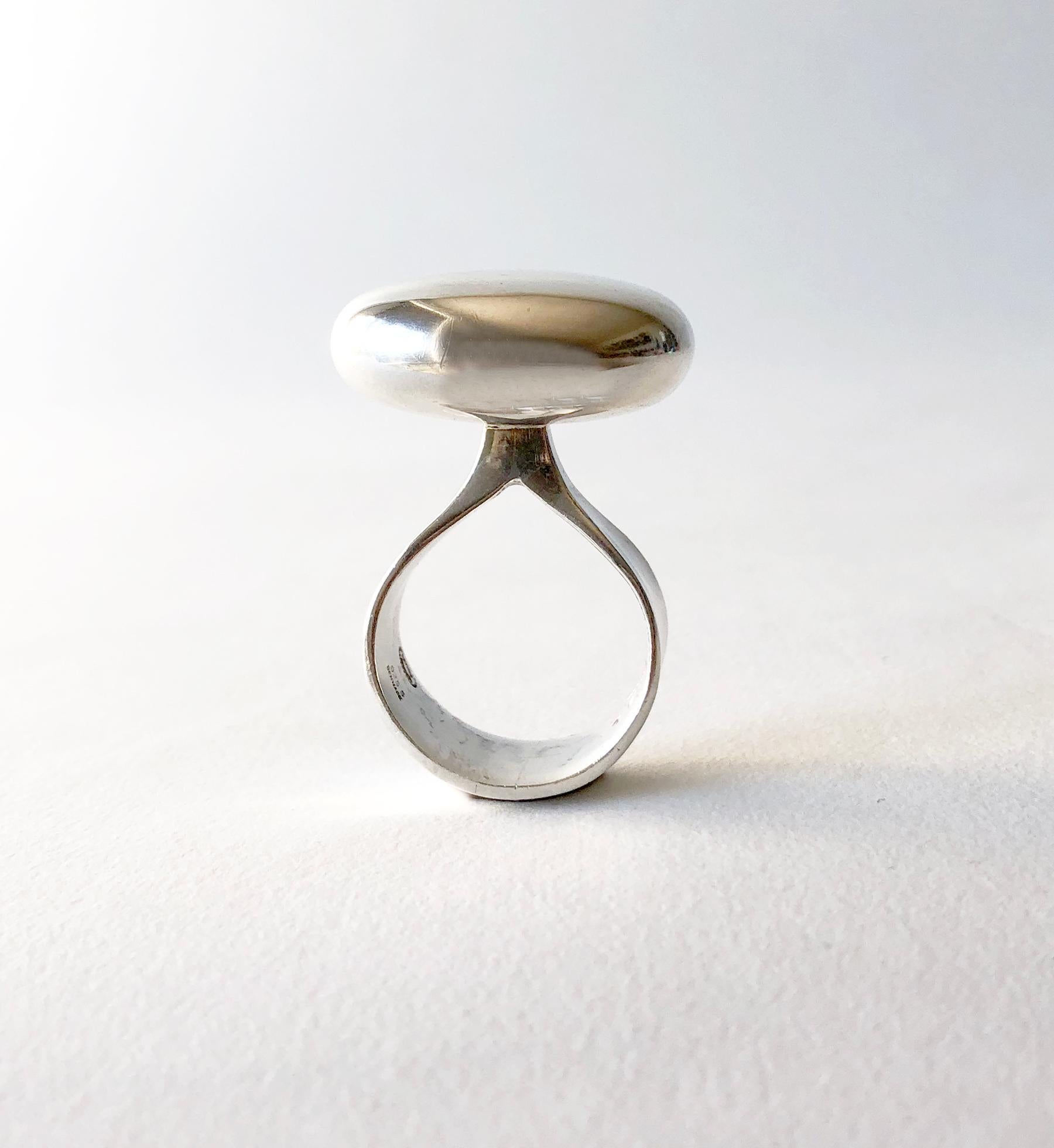 Mirror polish sterling silver ring designed by Vivianna Torun Bulow-Hube for Georg Jensen, circa 1970's.  Ring is a finger size 8 and is signed with the Jensen dotted hallmark, Torun, Denmark, 155.  In excellent vintage condition.