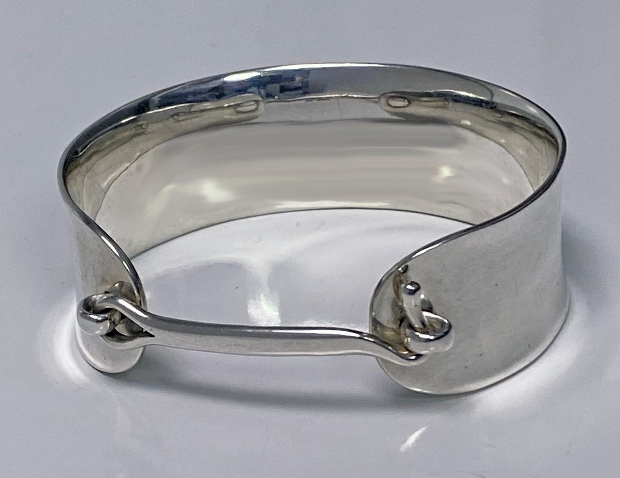 Vivianna Torun Rare Sterling Silver Cuff Bangle C.1960. This is rarely seen in this design. Substantial hand made slight undulating oval cuff bangle with central silver hook closure integral to design when depressed at sides. Will fit up to 8 inch