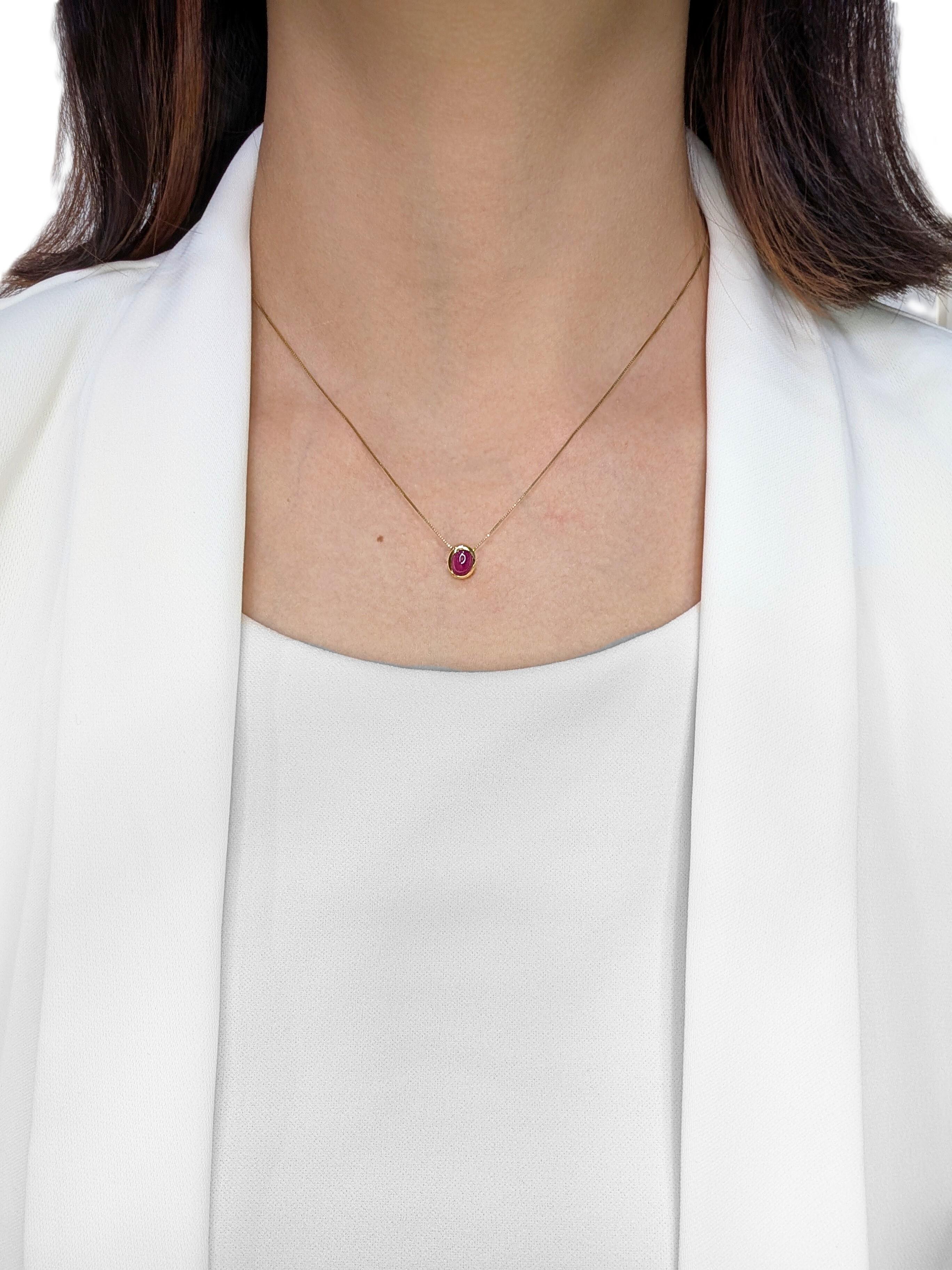 Introducing a vibrant new pendant that captures attention with its rich, warm tones. A captivating 0.8-carat natural ruby takes center stage, featuring a smooth cabochon cut that beautifully showcases its deep red hue. The ruby is elegantly set in a
