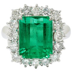 Vivid 7.70 Carat Colombian Emerald Diamond Platinum Cluster Ring GIA